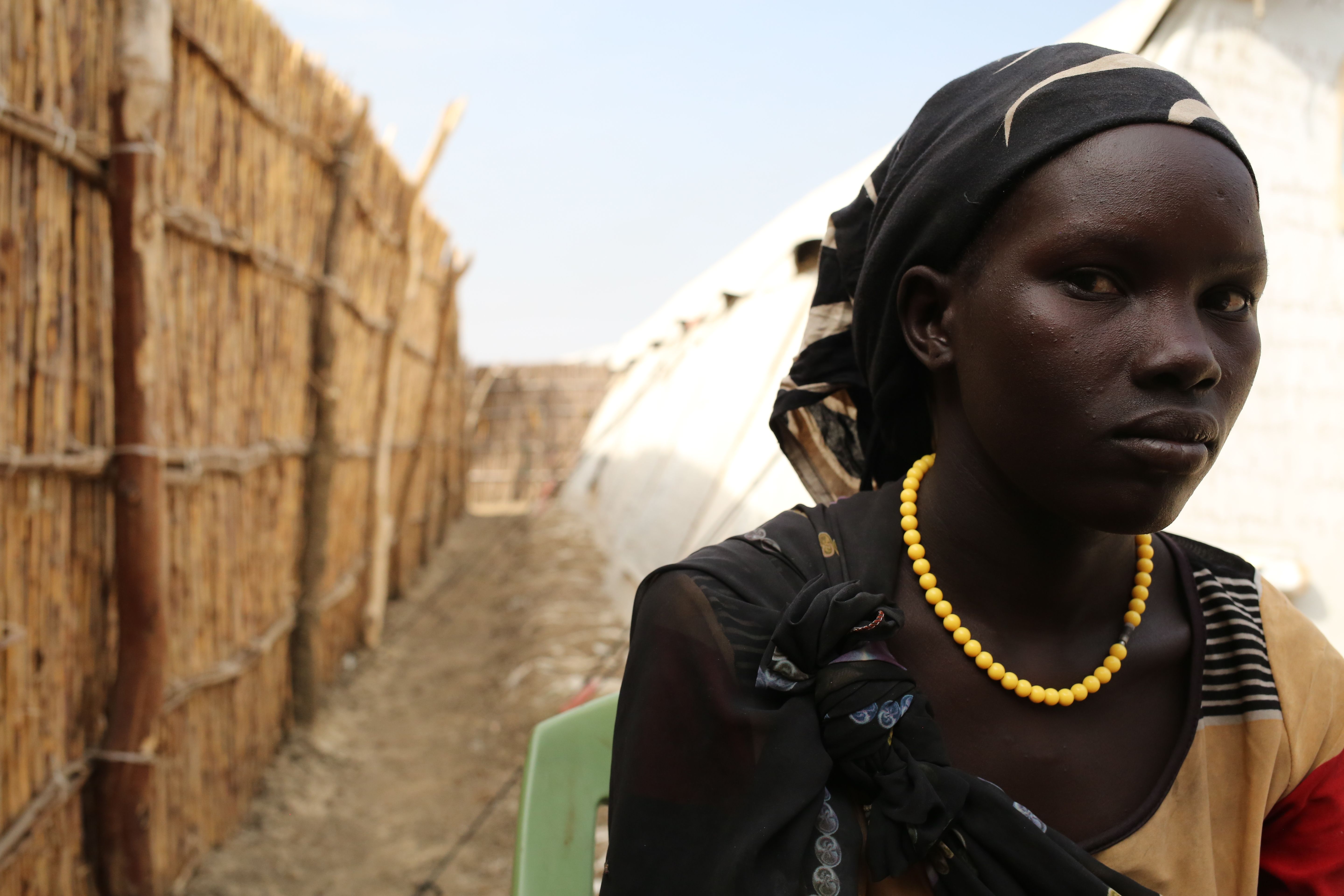 Elizabeth poses for a photo on Dec. 15, 2015 at the U.N. base in Bentiu, South Sudan. She fled recent fighting in Leer County. Image by Cassandra Vinograd. South Sudan, 2016.