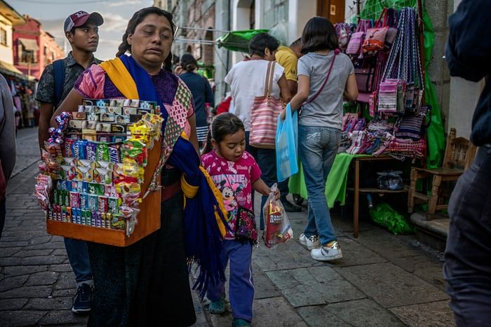 A street vendor and her daughter in Oaxaca city sell American sweets and cigarettes. More than a third of the state’s population is made up of 16 different indigenous groups. Image by James Whitlow Delano. Mexico, 2017.