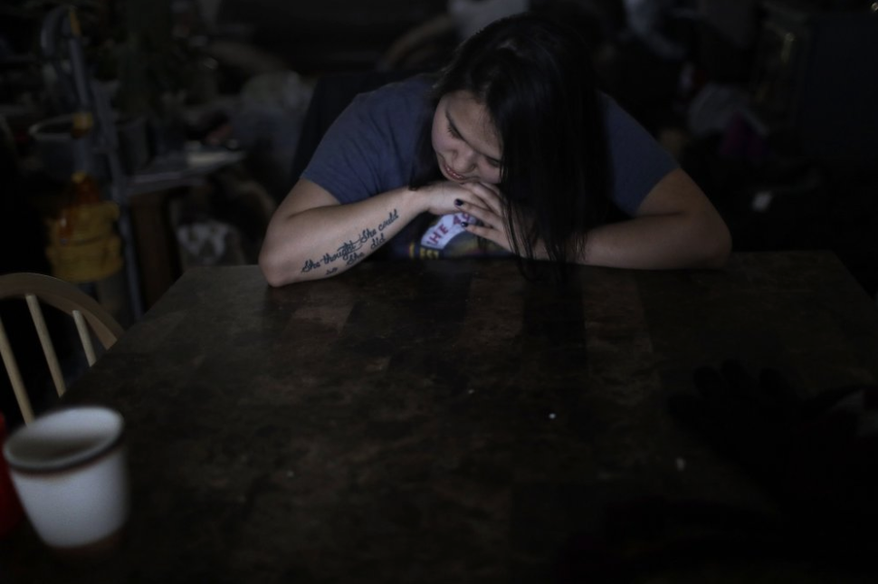 In this Feb. 16, 2019, photo, Deidre Levi rests her head for a moment in her grandmother's house before a basketball game in the Native Village of St. Michael, Alaska. Levi says she spoke up about being sexually assaulted because she wanted to be a role model for girls in Alaska. Image by Wong Maye-E. United States, 2019.