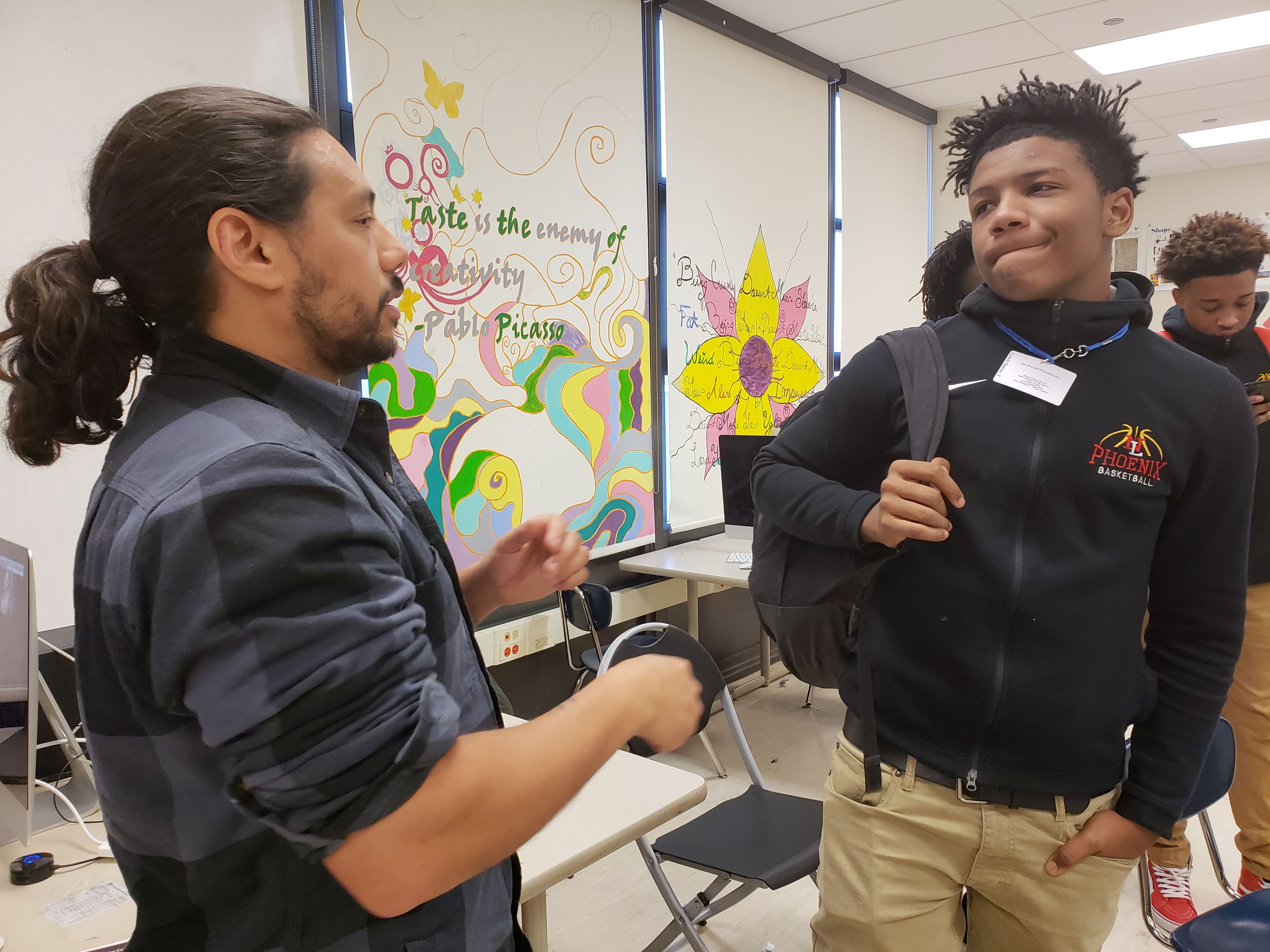 Photojournalist Brian Frank talks with students after class at North Lawndale College Prep. Image by Keta Glenn. United States, 2018.