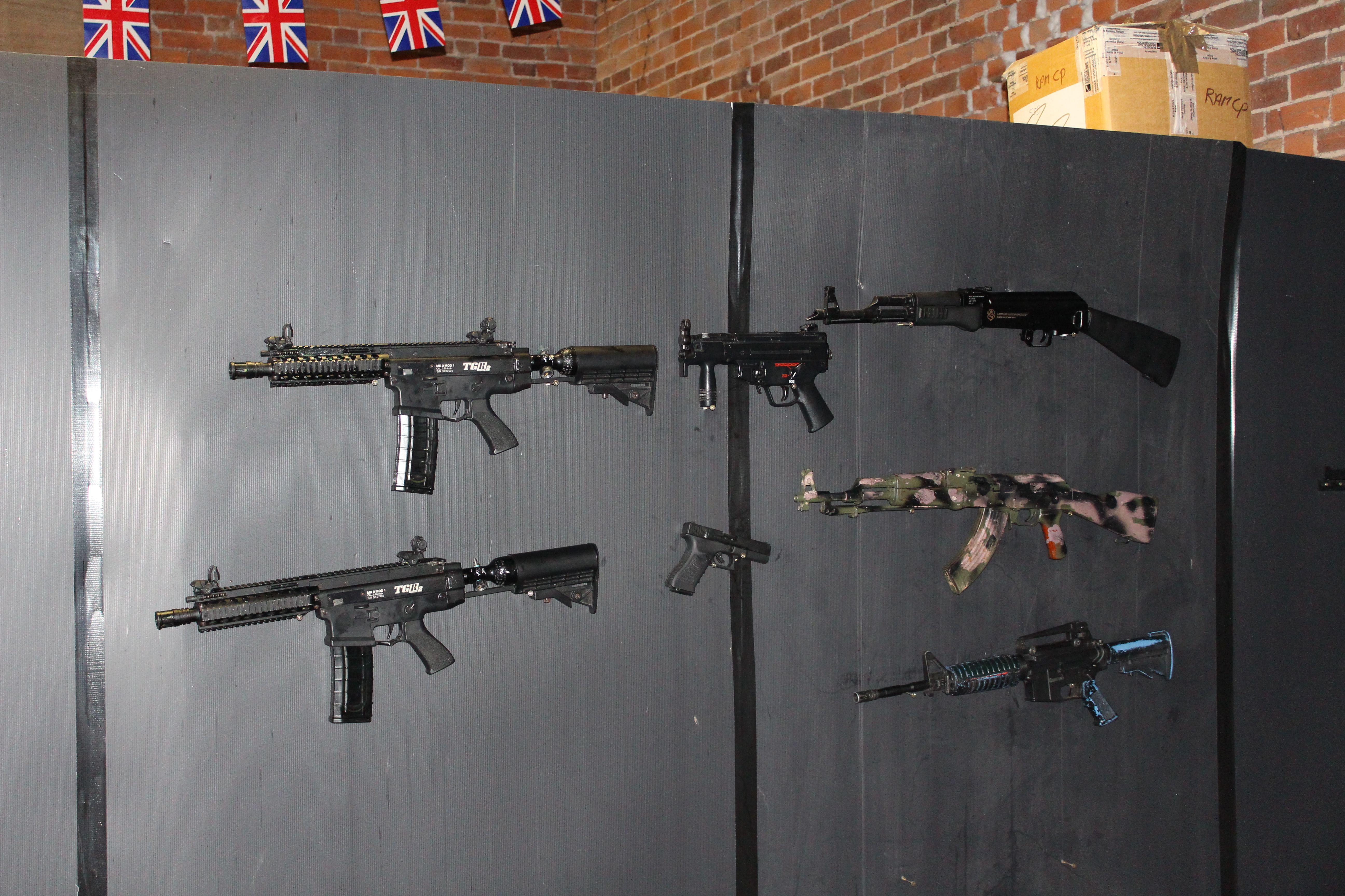 Guns line the wall of a private military company training centre in Hereford. Image by Matt Kennard. England, 2016.