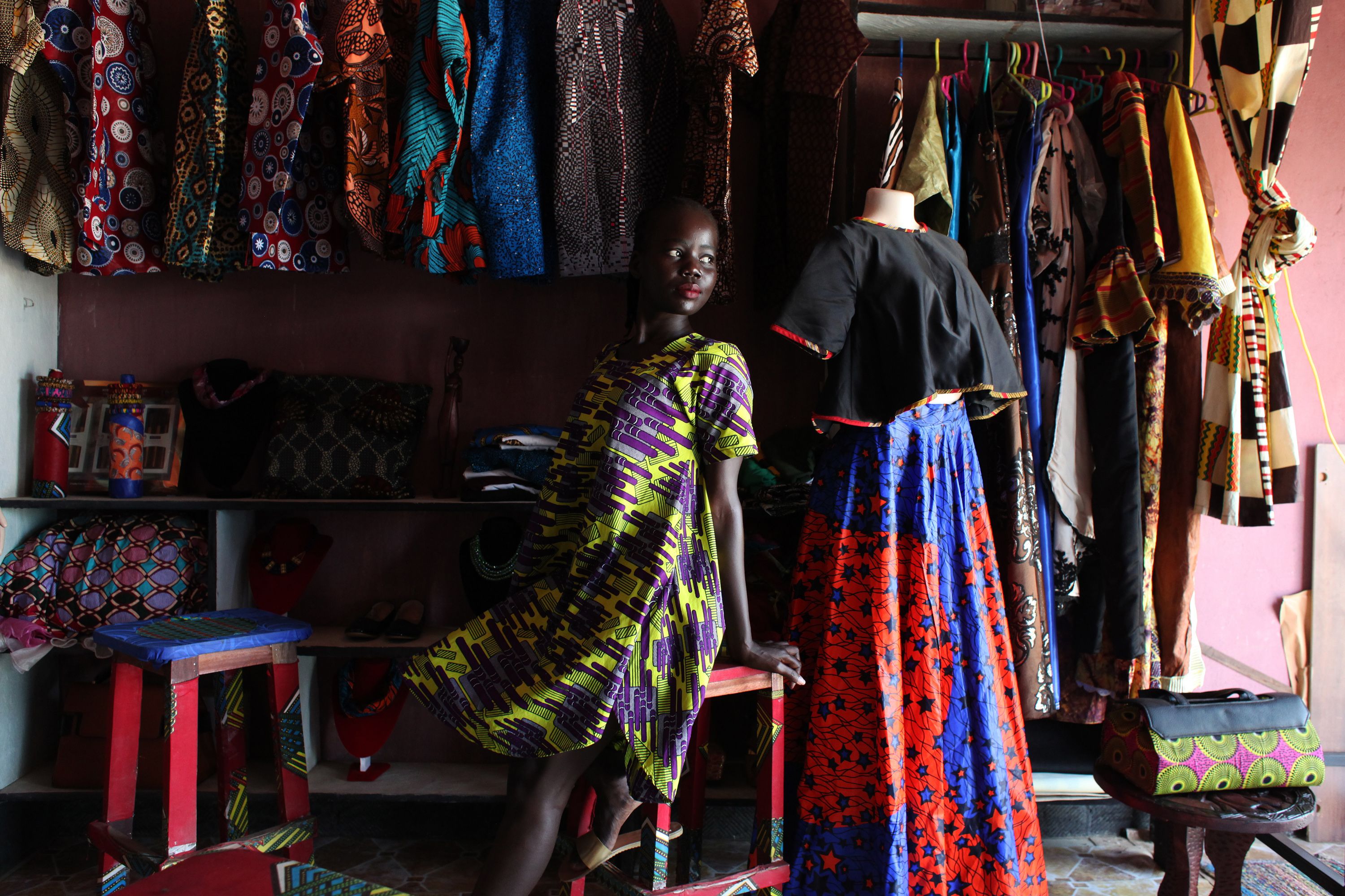 South Sudanese designer Winnie Godi is posing for a photo in her shop in Juba. Image by Andreea Campeanu. South Sudan, 2018.