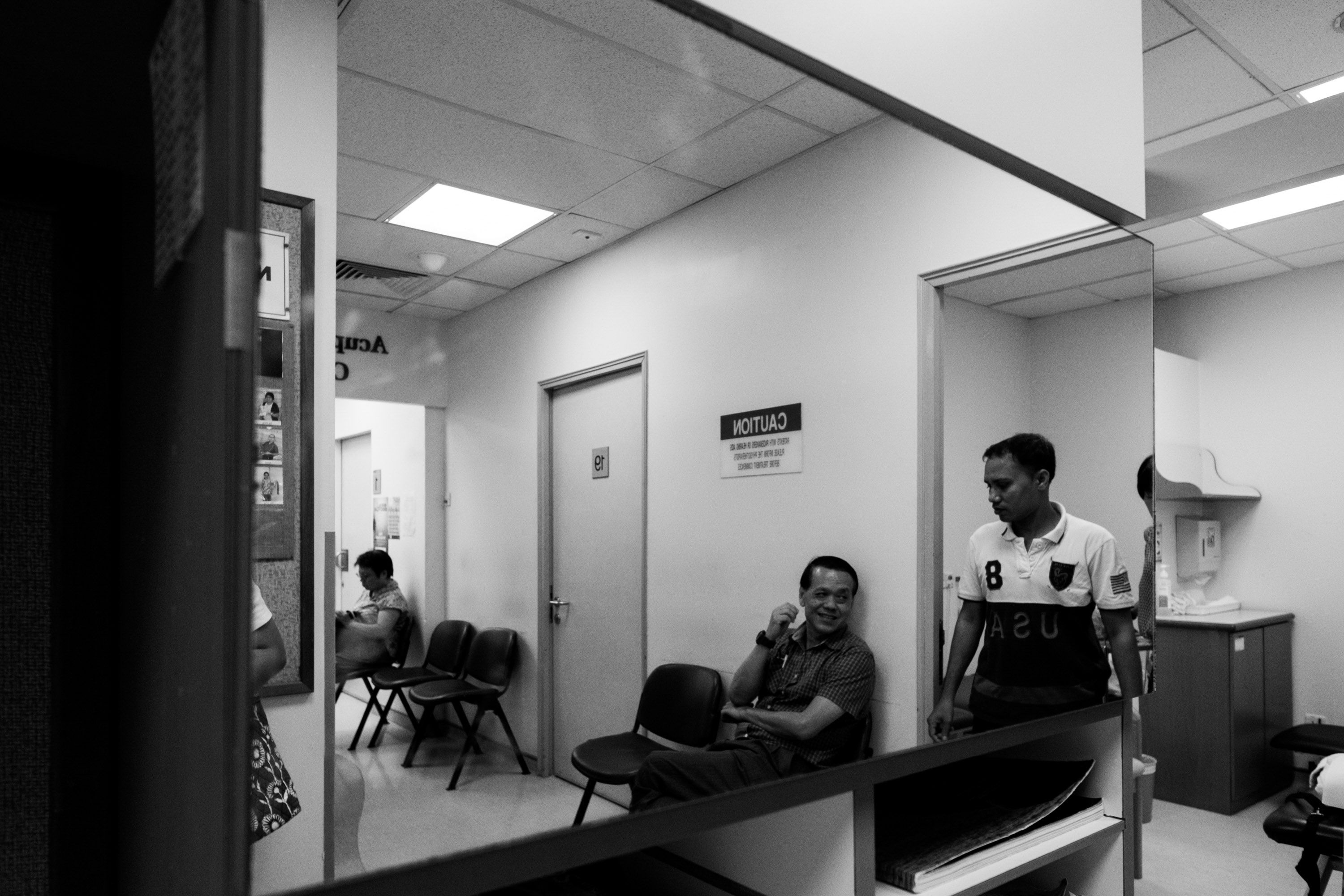 Mr. Haque leaving the doctor's office after his physical therapy session. Image by Xyza Bacani. Singapore, 2016.