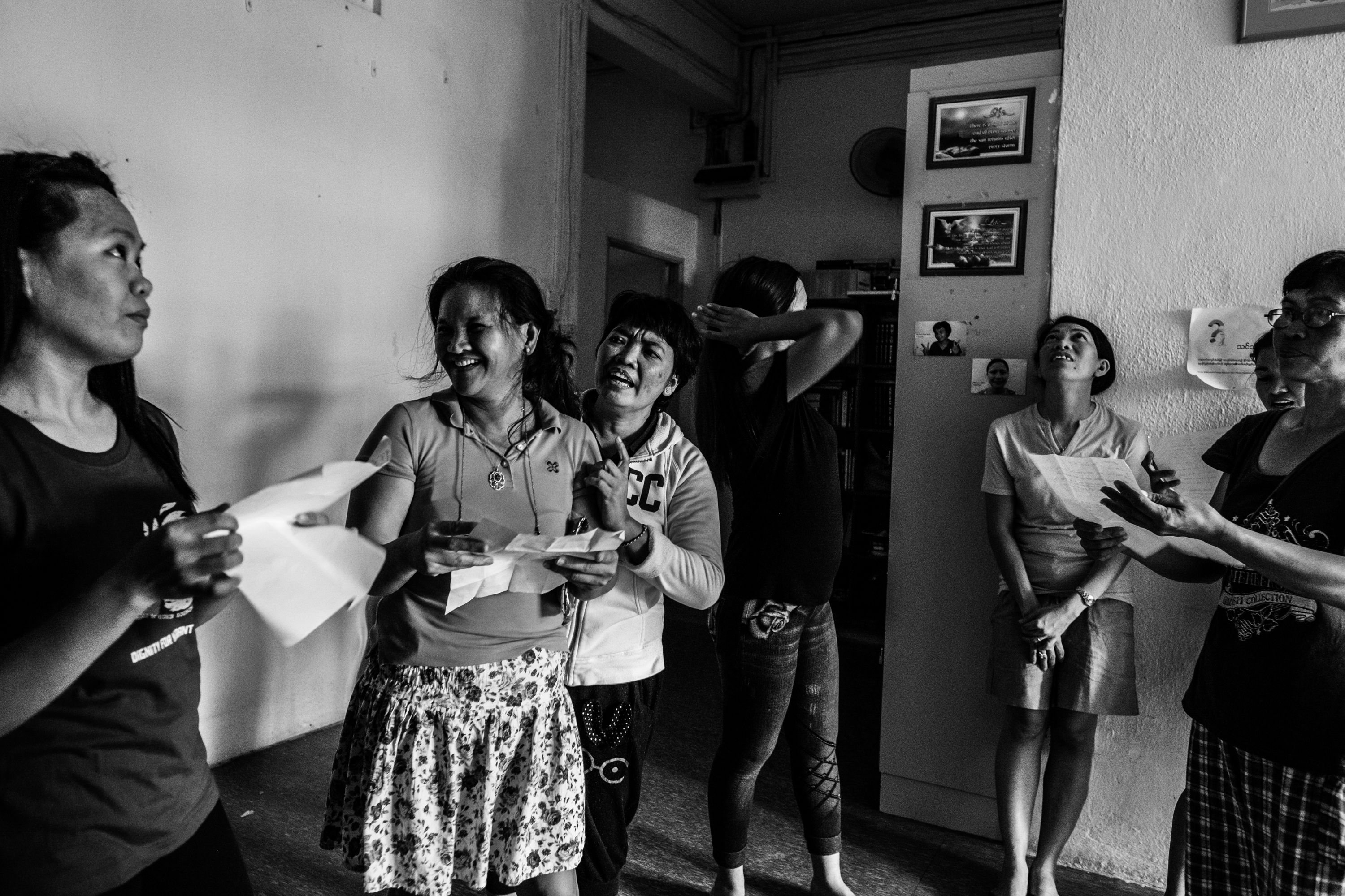 Runaway migrant workers practiced a song inside the shelter to stay active despite their painful situations.Image by Xyza Bacani. Singapore, 2016.