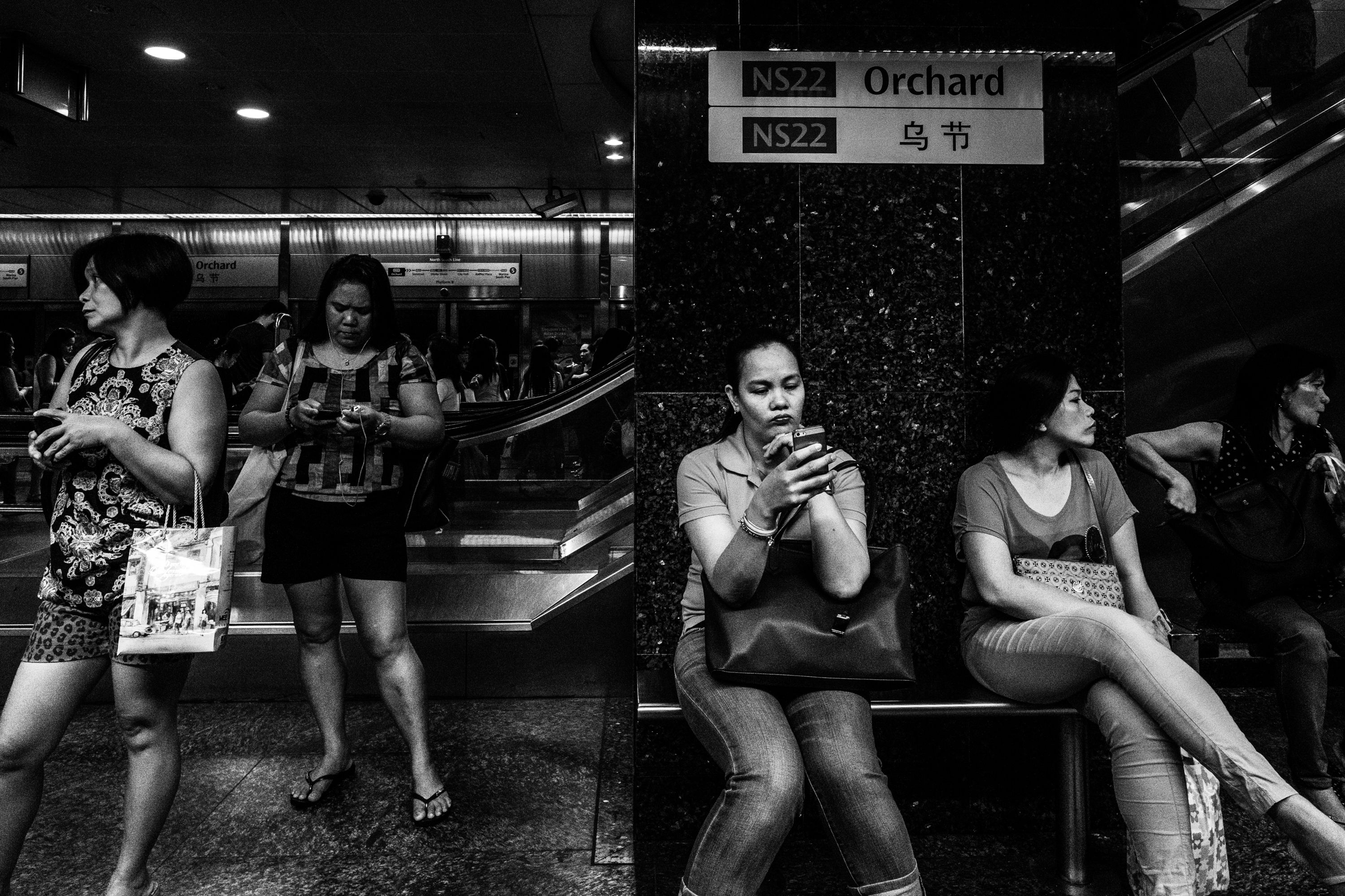 Migrant workers waiting for the train in Orchard, Singapore. Image by Xyza Bacani. Singapore, 2016.