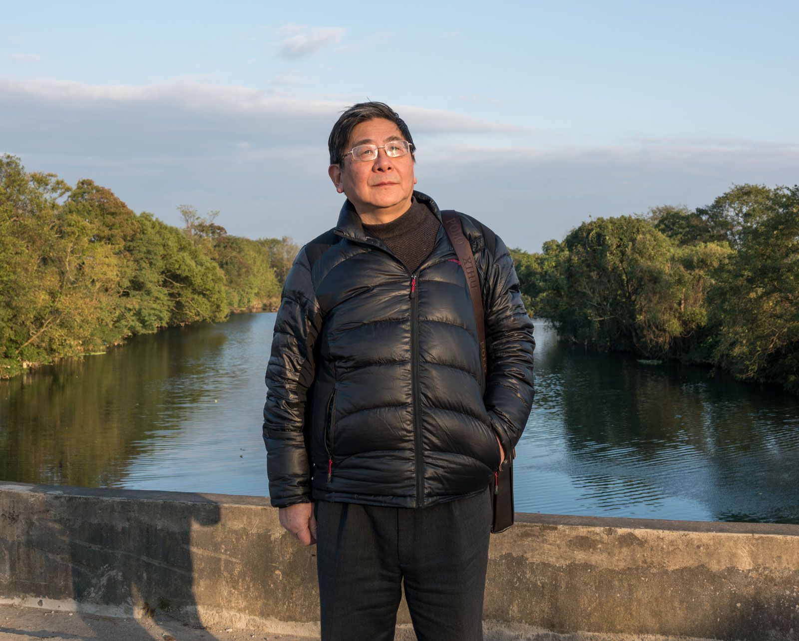 The author Tan Hecheng stands on "Widow's Bridge," where dozens of people were clubbed to death and thrown into the river in a wave of genocide that took place in 1967. These sorts of hidden histories still haunt the new superpower. Image by Sim Chi Yin/ VII Photo Agency. China, 2016.