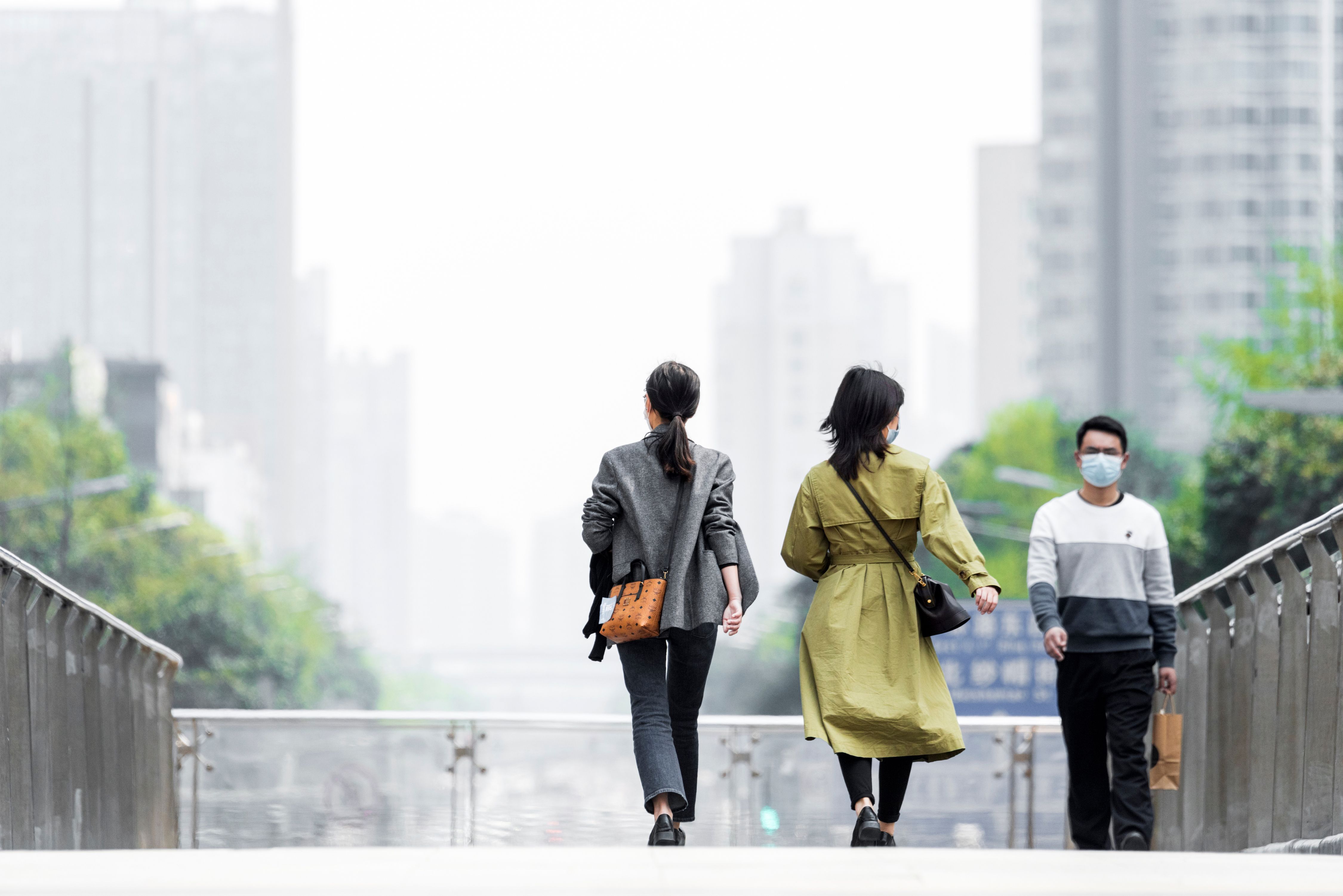 Shopping citizens in China's downtown center wear masks as the city recovers from the COVID-19 epidemic. Image by B.Zhou/Shutterstock. China, 2020