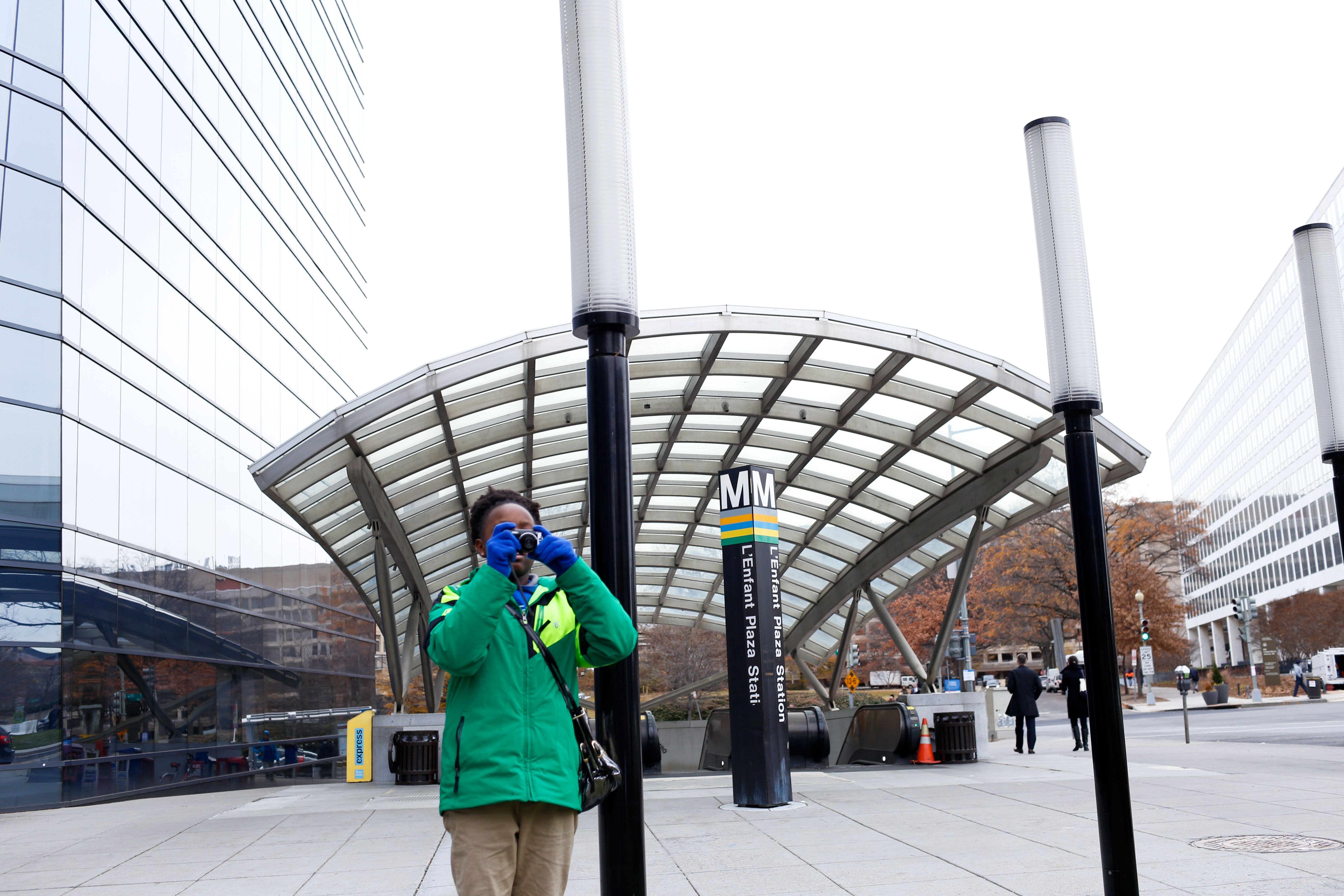 A Washington Global student takes a photo in L'Enfant Plaza. Image by Eslah Attar. United States, 2017.
