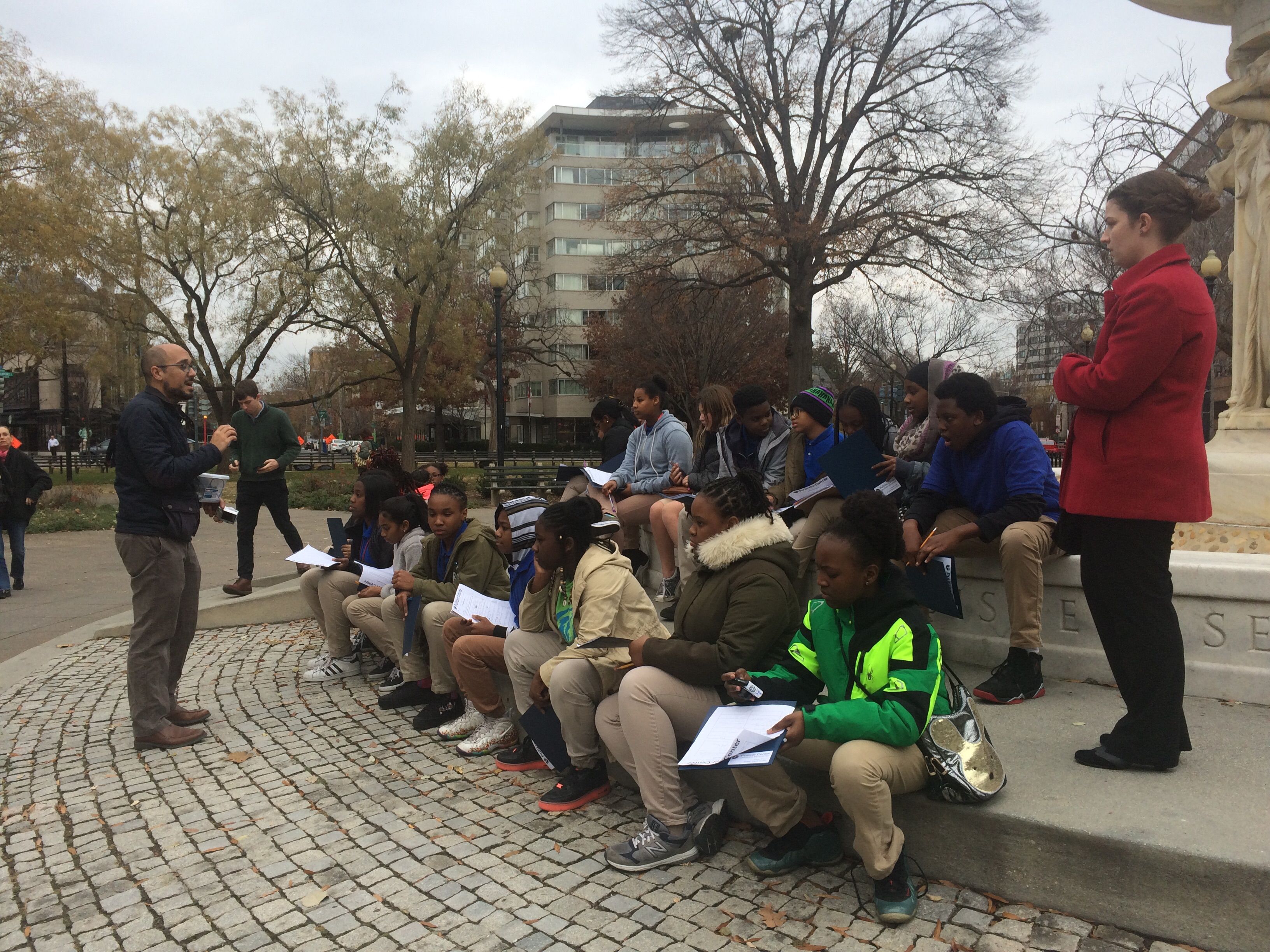 Senior education manager Fareed Mostoufi leads Washington Global students in a reflection on their second day of the Walk Like a Journalist workshop in Dupont Circle. Image by Hannah Berk. United States, 2017.