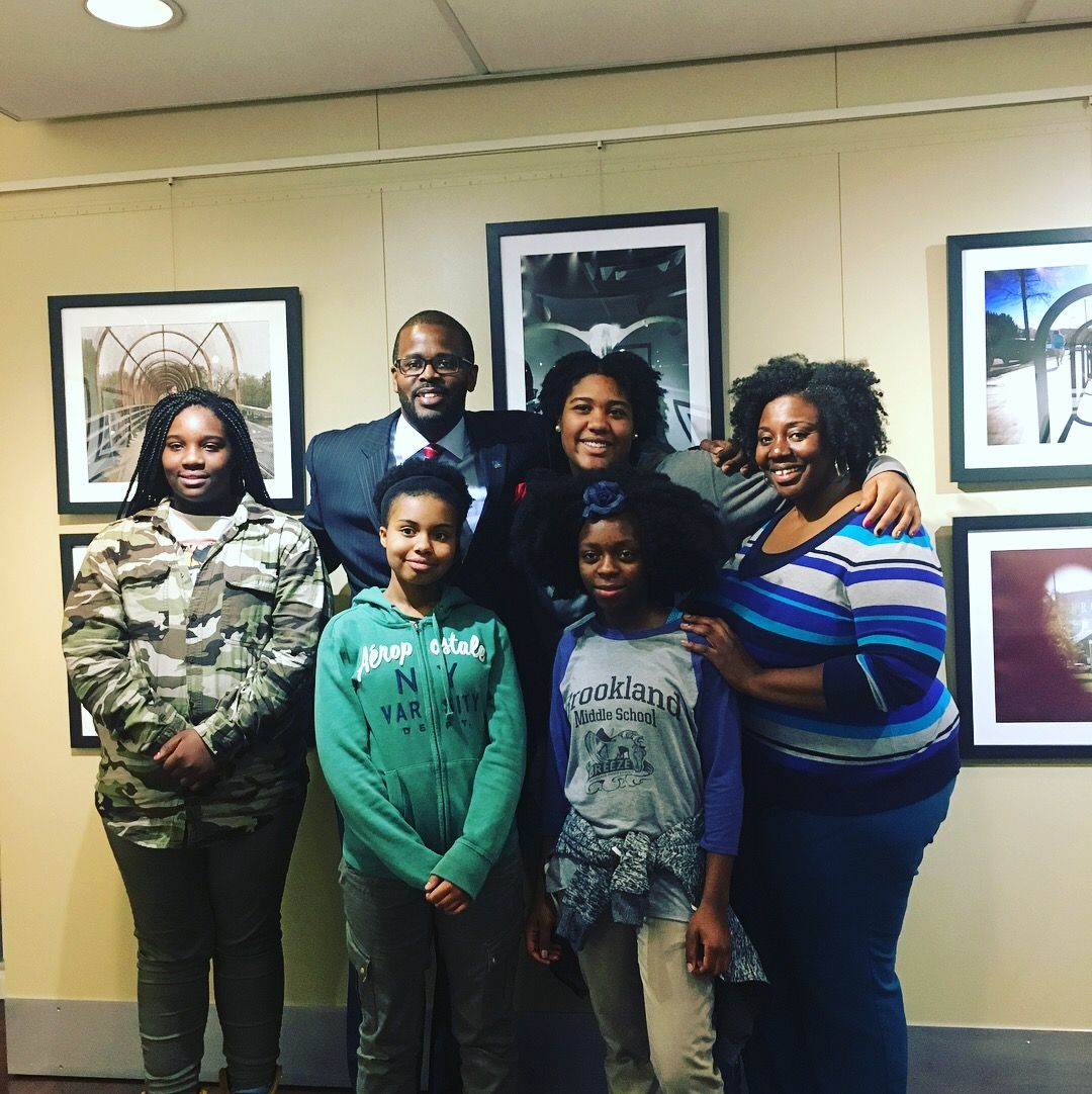 Washington, D.C. Public Schools Chancellor Antwan Wilson visits the Everyday DC exhibit with its student curators and their teacher.  Image by Fareed Mostoufi. United States, 2018.
