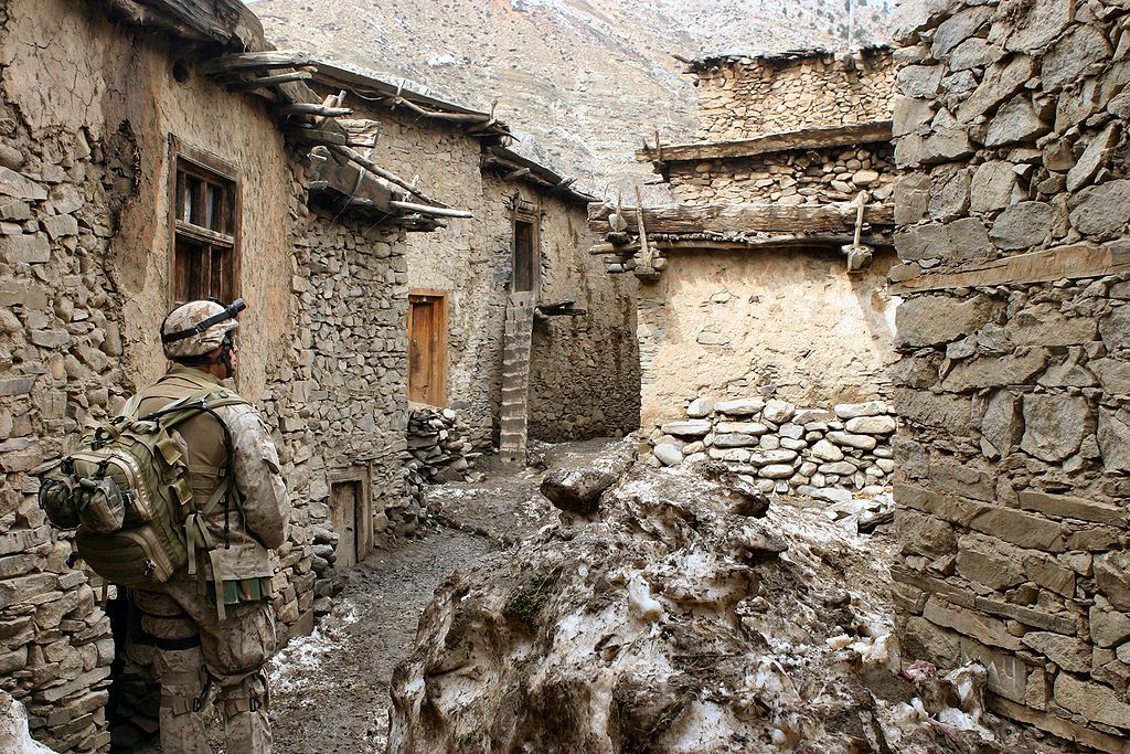 A soldier walks through an alley in the vicinity of Methar Lam. Image by Cpl. James L. Yarboro. Afghanistan, 2005. 
