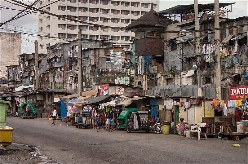 A Manila street scene showing informal housing and shops.