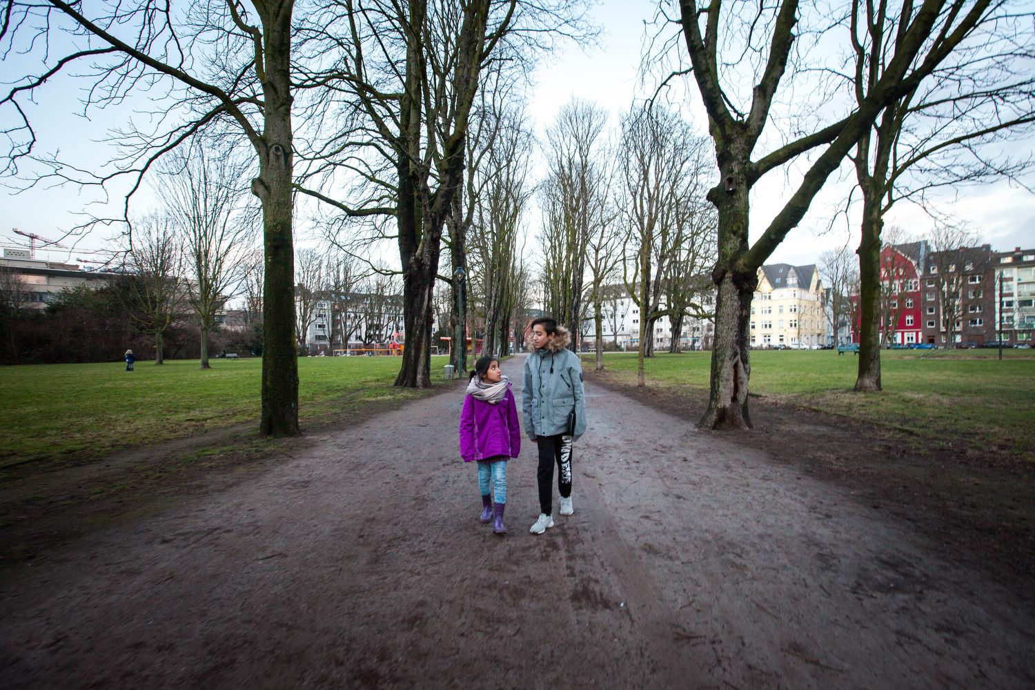 Milad (right) with his sister Mahya at the Frankenplatz park near their shelter in Düsseldorf. Image by Diana Markosian. Germany, 2017.