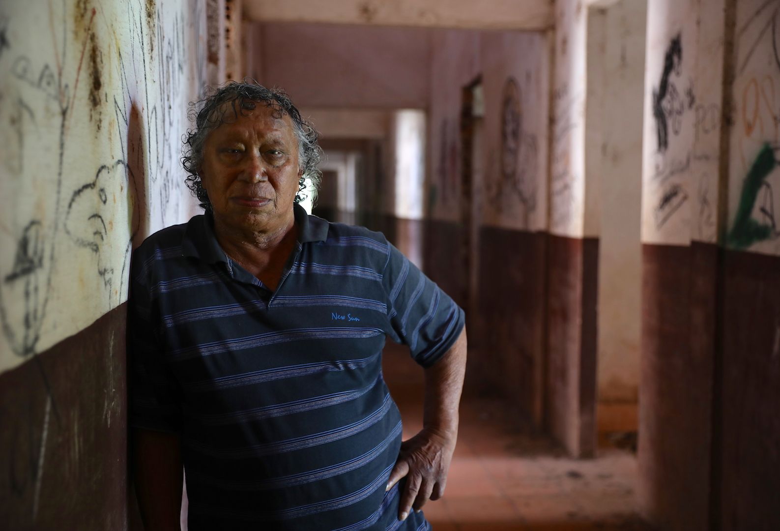 Agenor Gomes Cardoso, who was relocated to the Prata Colony after being diagnosed with leprosy, leans on the walls of the now-abandoned hospital, where he had received treatment. Image by Anton L. Delgado. Brazil, 2020.