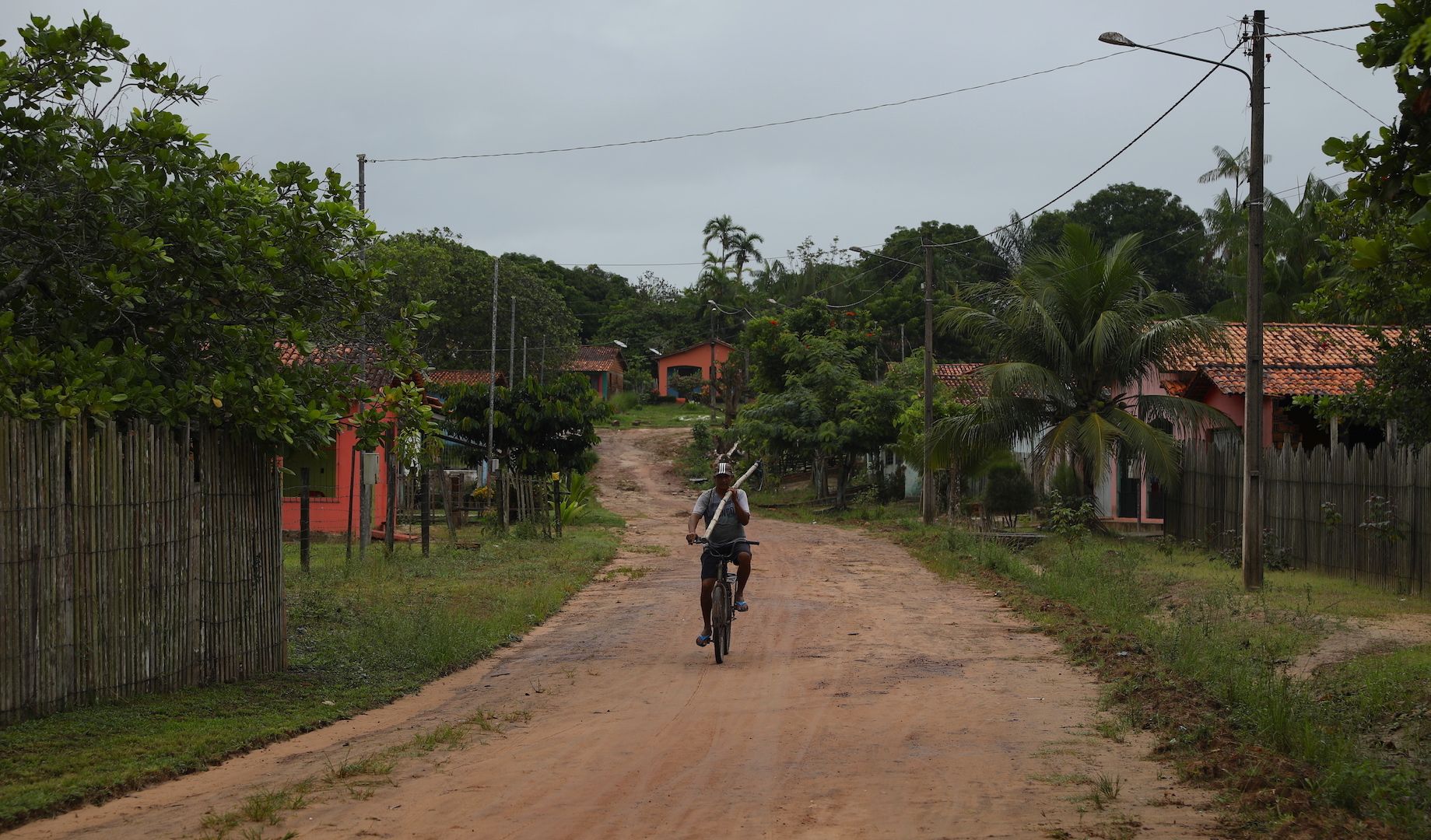 One of Prata’s residents bicycles down one of the several dirt paths connected to the only paved road in the village. Image by Anton L. Delgado. Brazil, 2020.