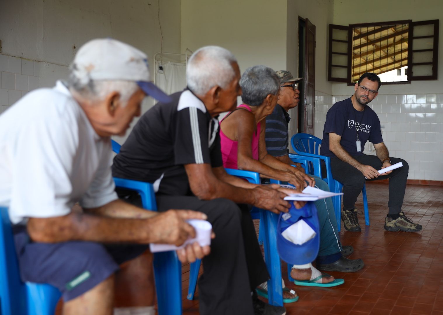 Fellow residents and Dr. Josafá Barreto, a physical therapist, listen to Cardoso speak during one of Prata’s public town hall meetings. Image by Anton L. Delgado. Brazil, 2020.