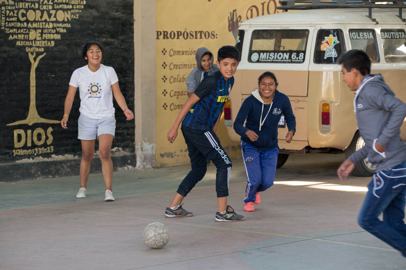 Young people play soccer at Villa Galindo Baptist Church in Cochabamba. Some children go to the church on weekends while their parents work. Others come from San Sebastian prison, which is overcrowded and has no playground. "Soccer, jumping around, it's part of letting off steam," Pastor Alex Villarroel said. Image by Tracey Eaton. Bolivia, 2017.