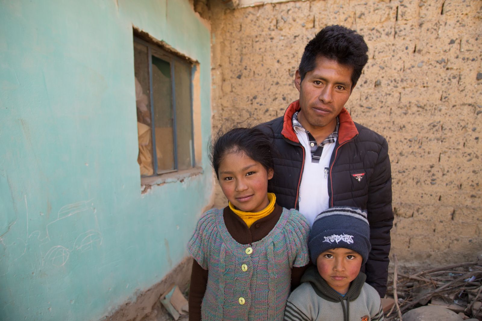 Victor Corhuari has been searching for his sister, Zulma, who was 16 when she went missing in April 2017. He is a single father and lives with his daughter Deysi, his son Neymar, and his sister's child, not shown. Image by Tracey Eaton. Bolivia, 2017.