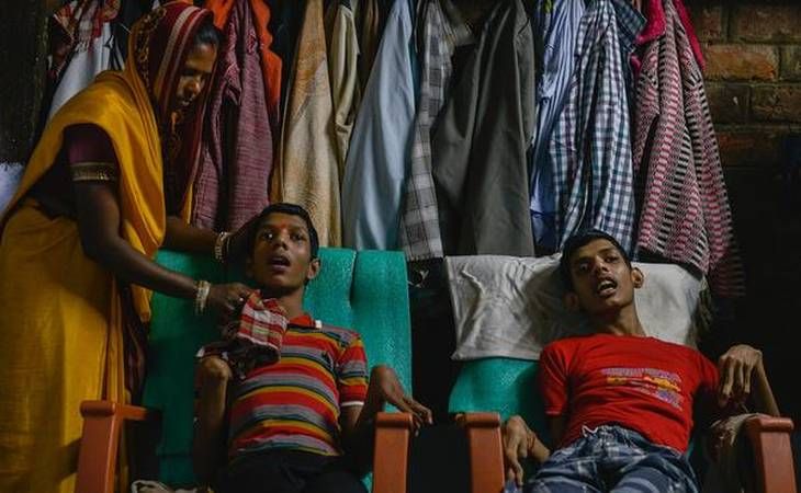 Living victims: Vikas Yadav, 19, and Aman Yadav, 17, brothers, have muscular dystrophy and are being cared for by their mother at their home. Affected by toxic waste which seeped into the groundwater, they will live short, painful lives. Image by Rohit Jain. India, 2018. 