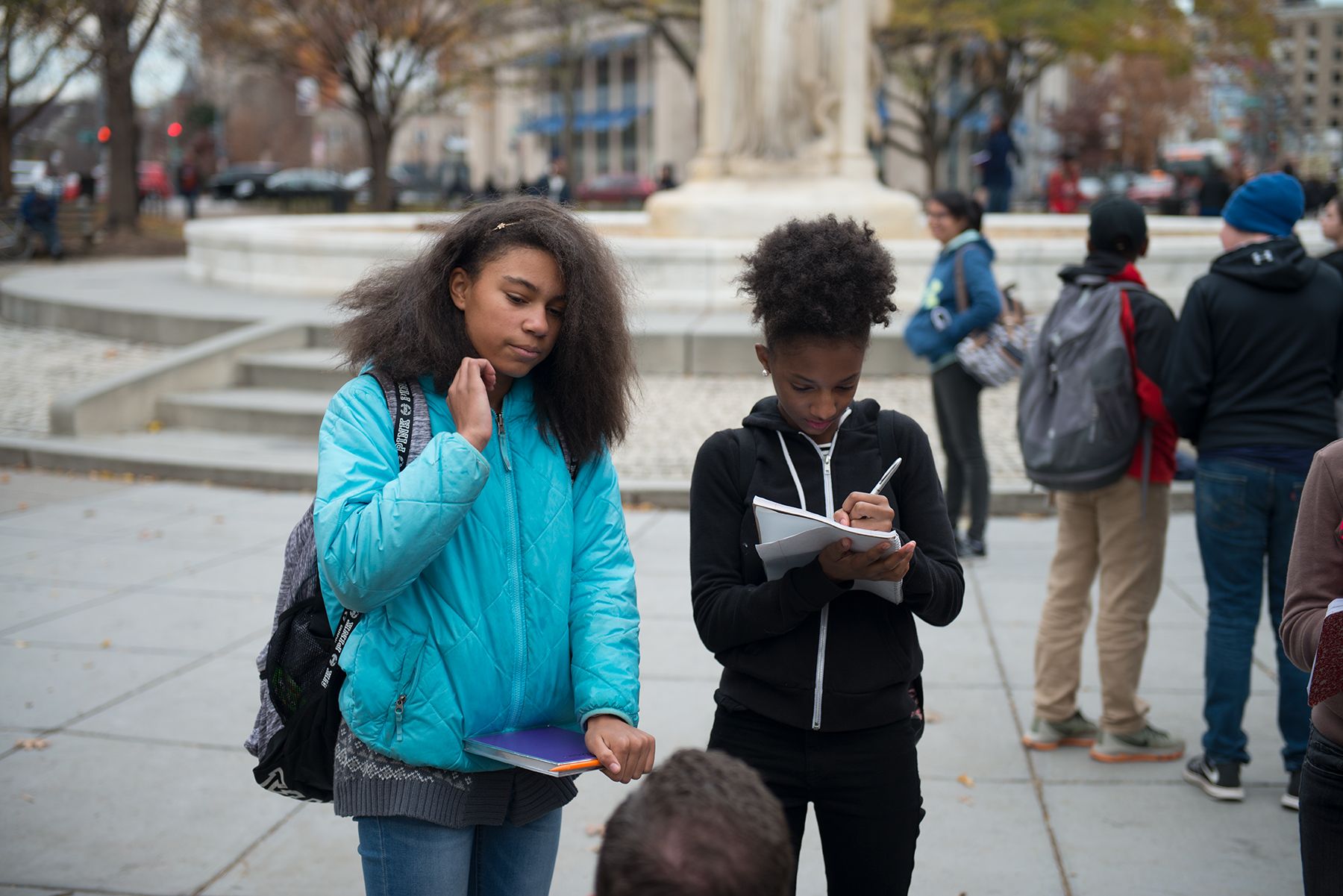 Students from Hardy Middle School conduct interviews in Dupont Circle as part of day two of the "Walk Like a Journalist" workshop, where their eighth grade class practiced observation, interviewing and reporting around D.C. Image by Jordan Roth. Washington, D.C., 2017.