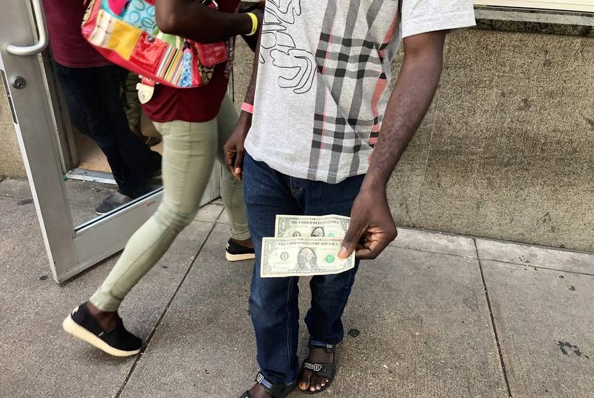 Evaristo, a migrant from Angola traveling with his wife and three kids, arrived at San Antonio's Migrant Resource Center the last week of June with $2 in his pocket. Image by Jay Root. United States, 2019.