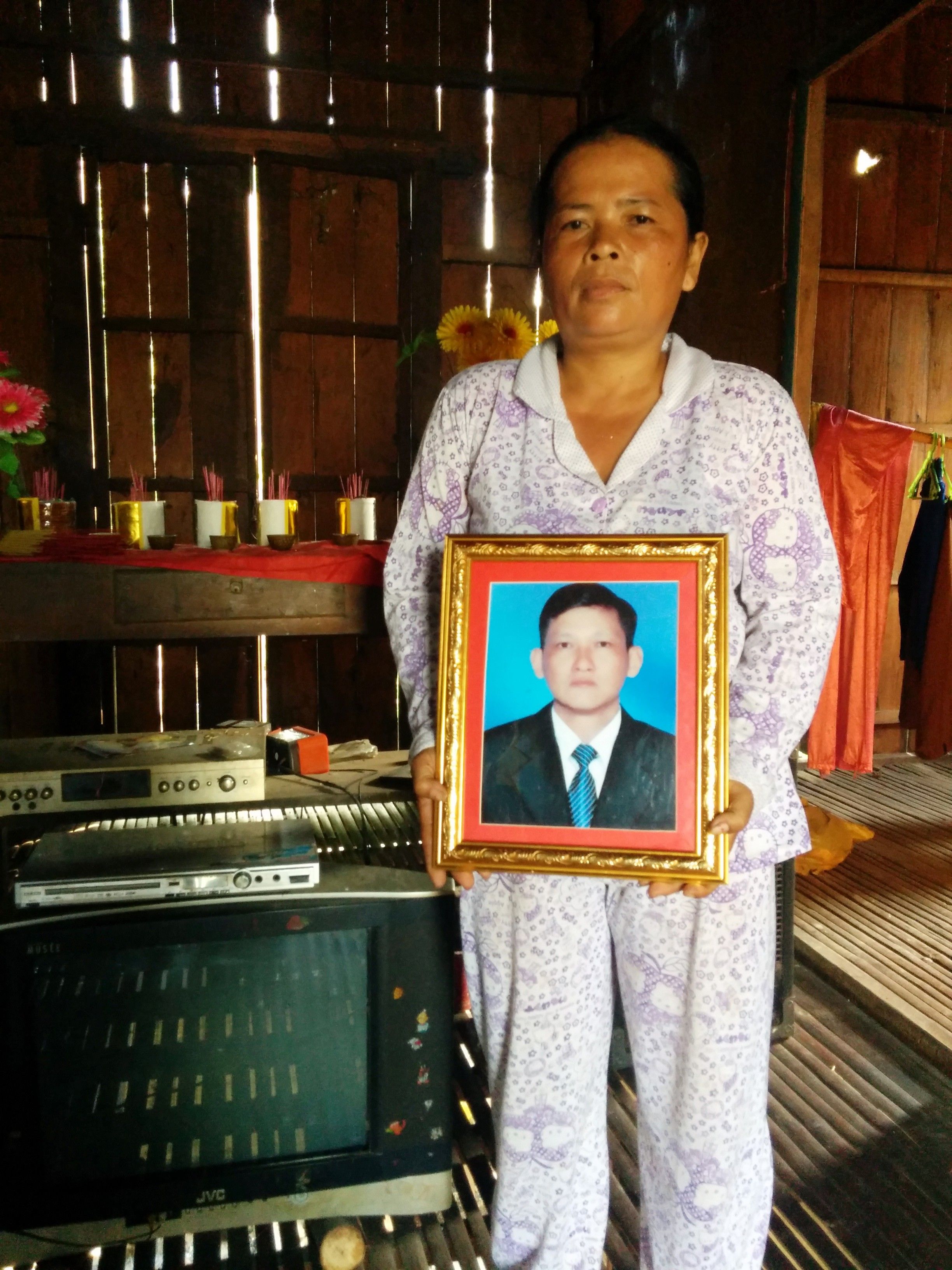 Cheam Mom holds a picture of her husband, murdered journalist Taing Try