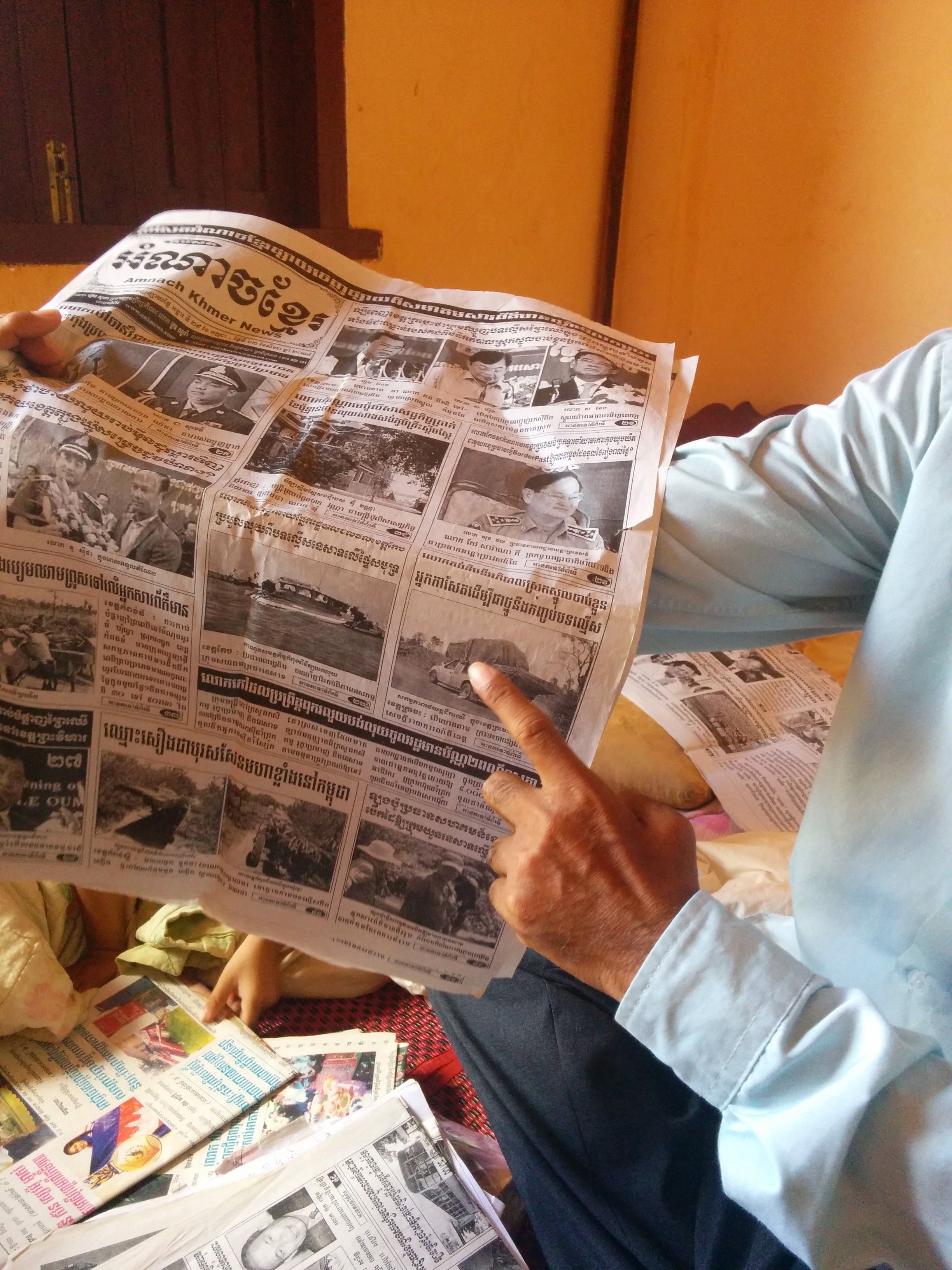 Journalist Sa Piseth shows one of his articles on illegal logging in the Reaksmey Kom Khmer newspaper