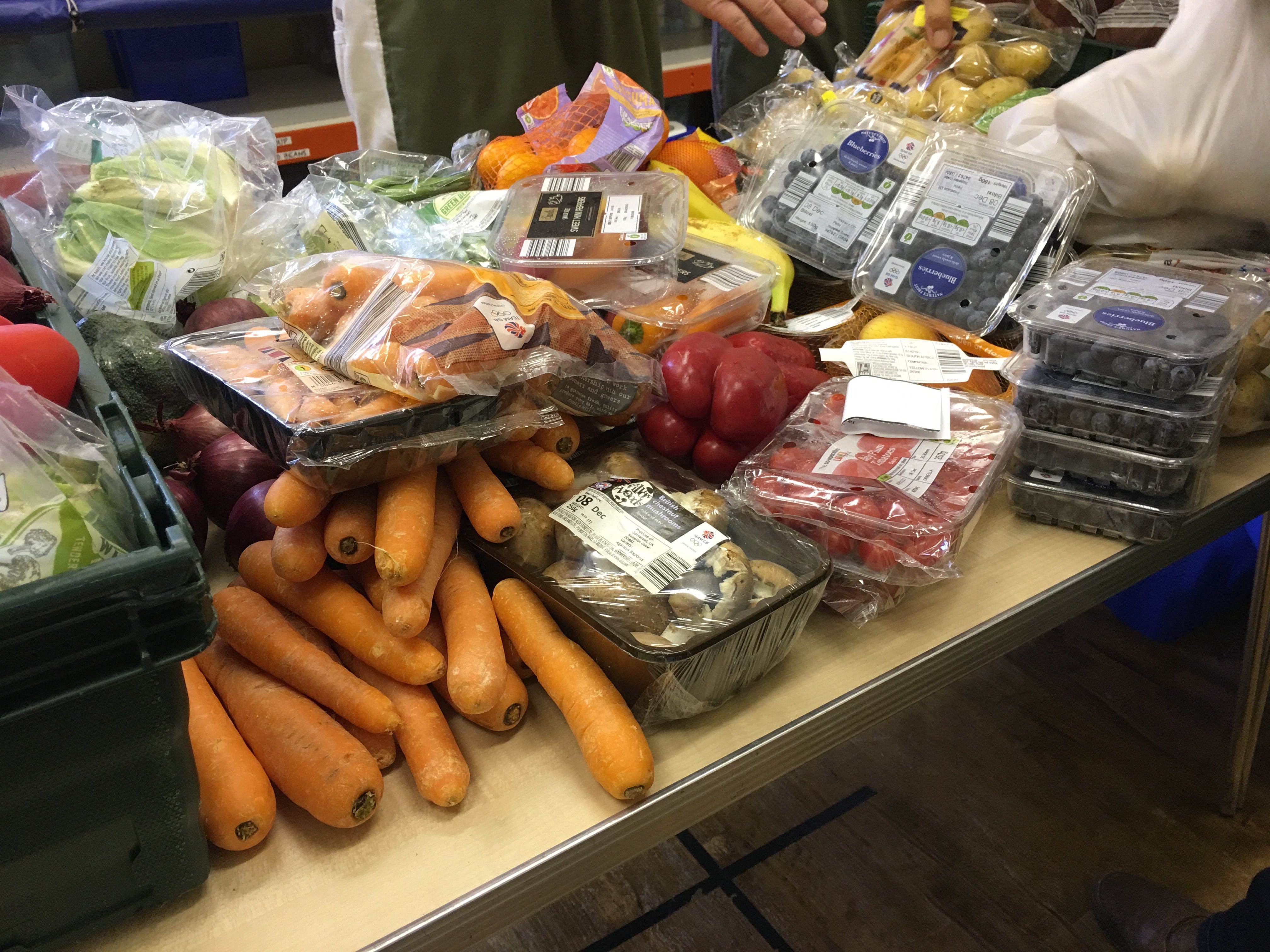 Fresh fruit and vegetables are not usually available at food banks, but due to a partnership with other local organisations the team is able to offer them alongside their usual non-perishable items - highly important in helping clients' nutrition. Image by Caitlin Bawn. England, 2016.