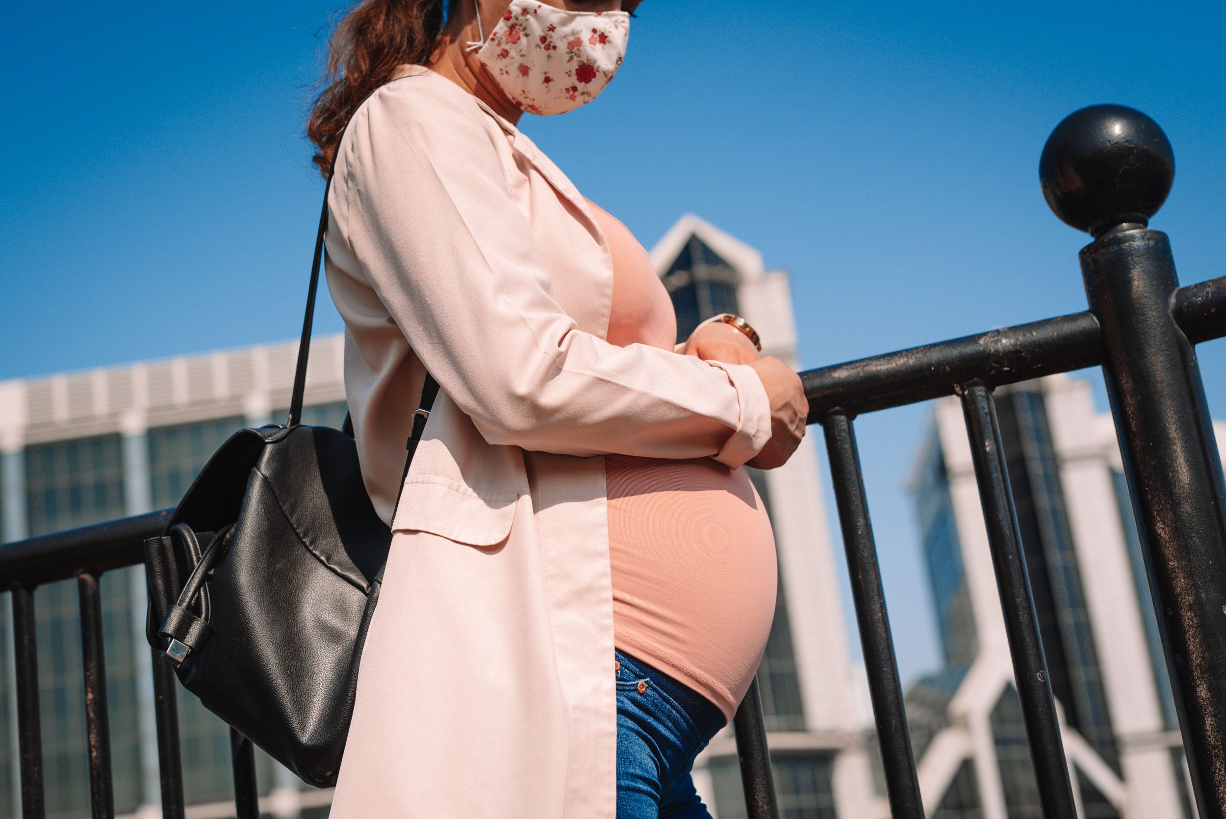 A pregnant woman walks down the street in London. Image by Corpii / Shutterstock. United Kingdom, undated.