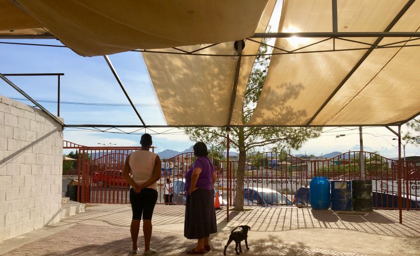 Sister Maria Antonia Aranda and a migrant woman from Cuba confer outside a church in Juárez, Mexico in August 2019. Image by Lily Moore-Eissenberg. Mexico, 2019.