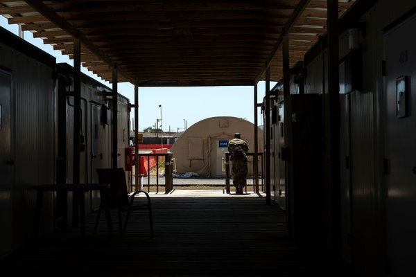 An obsolete airstrip with tents and containerized housing at Guantánamo Bay is the site of the death-penalty trial of the men accused of plotting the Sept. 11, 2001, attacks. Image by Doug Mills / The New York Times. United States, 2019.