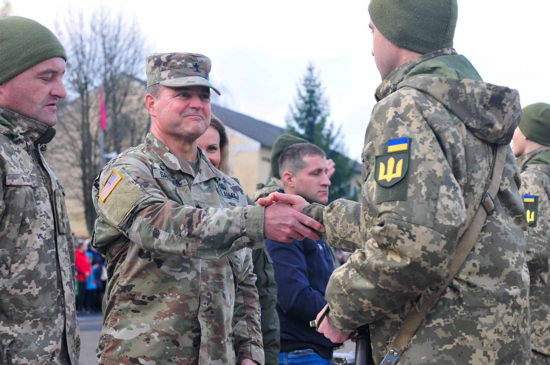 Lt. Col. Clay Salmela, the chaplain with Task Force Juvigny, congratulates a Ukrainian soldier upon completion of initial entry training at Starychi Military Base near Combat Training Center–Yavoriv, Ukraine. Image by Cpl. Jared Saathoff / Wisconsin National Guard Public. Ukraine, 2020.