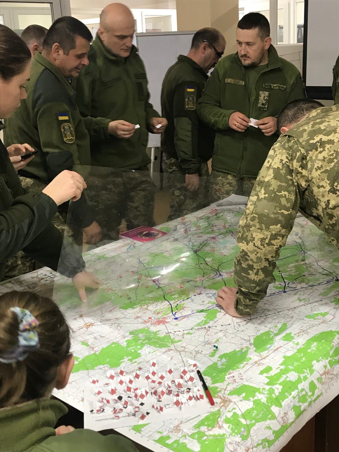 Ukrainian soldiers prepare to play a war game at a combat training center in western Ukraine. A Wisconsin National Guard unit arrived in November to mentor Ukrainian military trainers. Image by Meg Jones / Milwaukee Journal Sentinel. Ukraine, 2020.