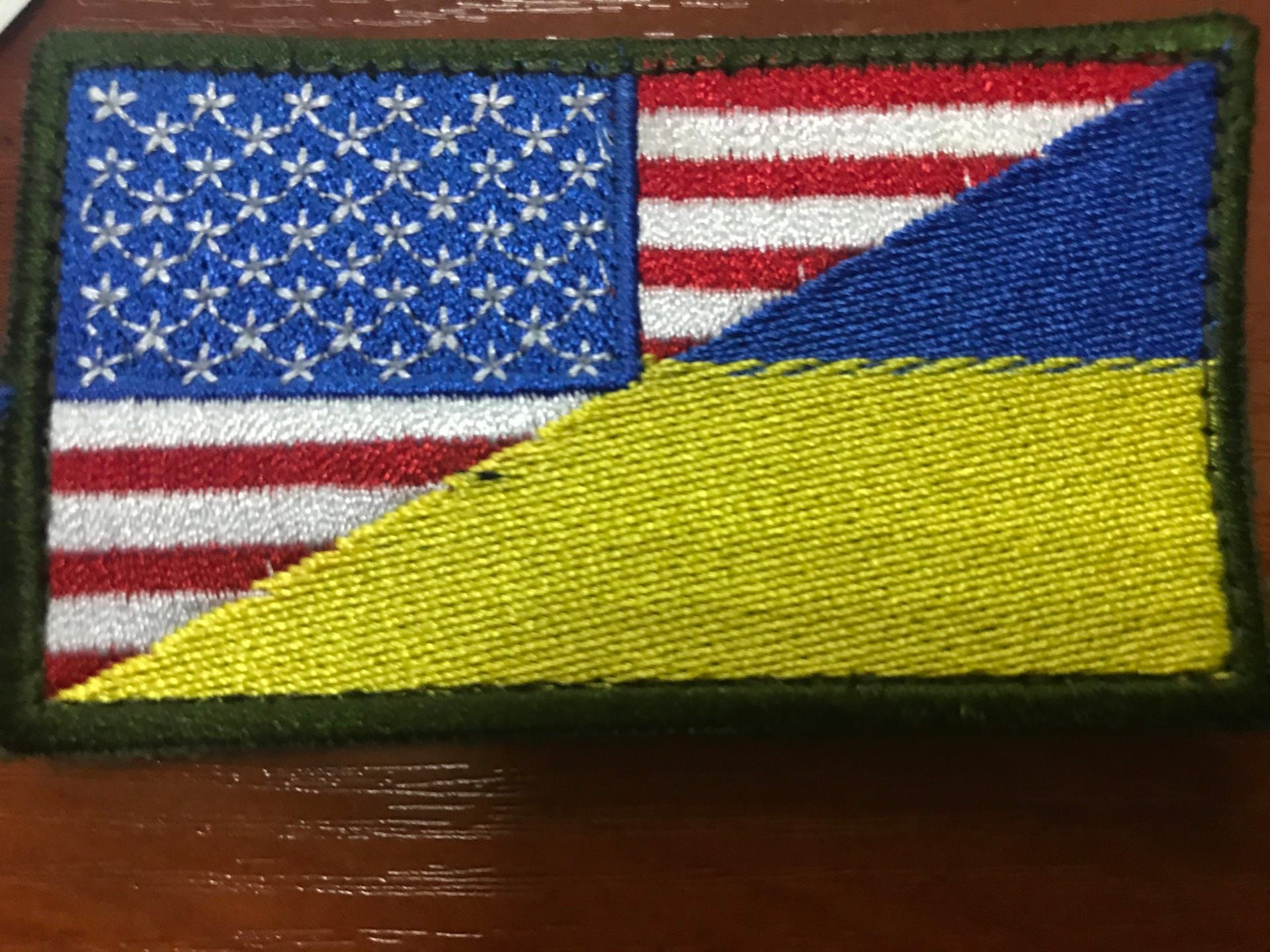 A patch featuring the American and Ukrainian flags at a combat training facility in western Ukraine. U.S. and coalition forces opened the training center a year after Russia invaded Crimea in eastern Ukraine. Image by Meg Jones / Milwaukee Journal Sentinel. Ukraine, 2020.
