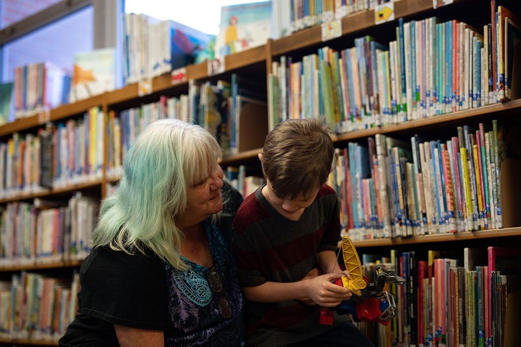 Anna Koski spends time with her grandson Aiden at the Miami Public Library. Aiden is the son of Koski’s younger daughter Jennifer. She hasn’t seen Elizabeth’s kids for several years. Image by Destiny Green / KOSU & The Frontier. United States, 2020.