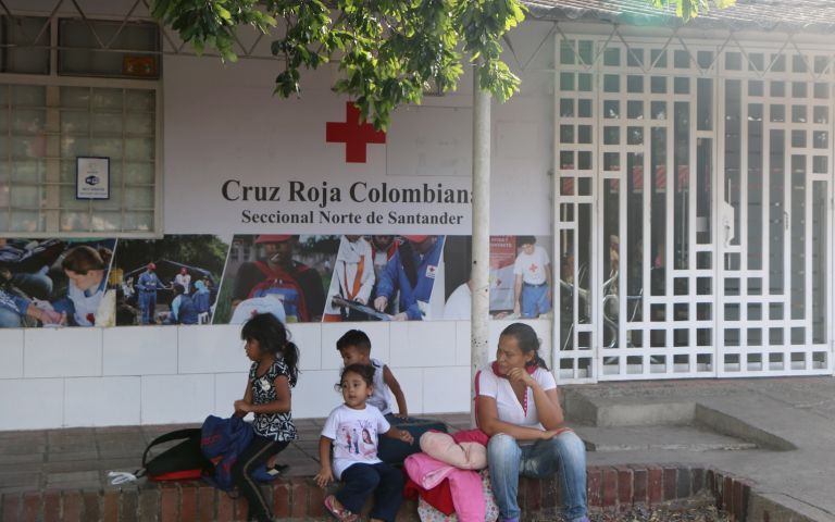 A Venezuelan family waits outside a Red Cross center in Norte de Santander. Image by Patrick Ammerman. Colombia, 2019.