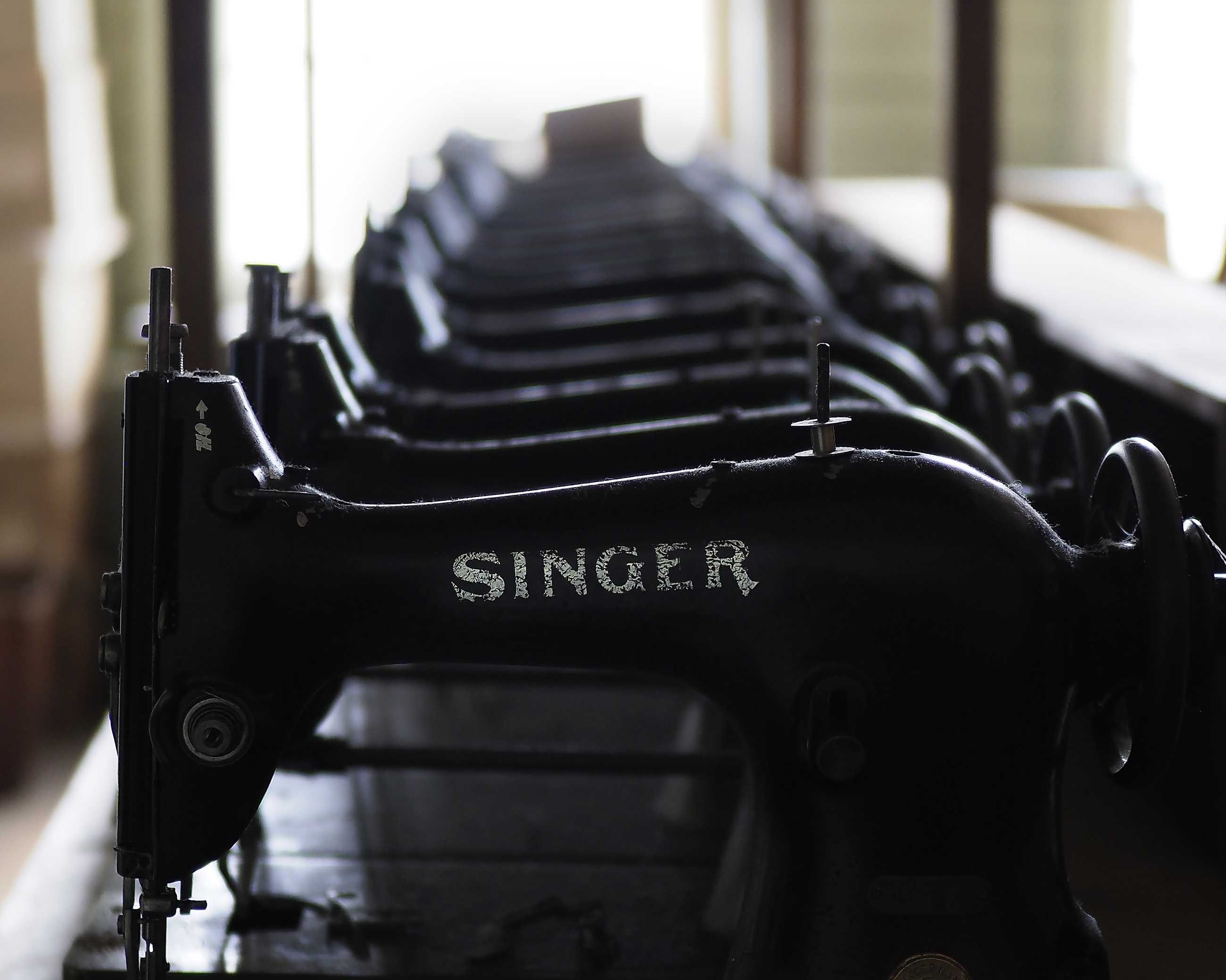 A row of old Singer sewing machines stacked in a storeroom at Samco recalls the region’s heyday as the self-proclaimed glove-making capital of the world. Image by Larry C. Price. United States, 2016.