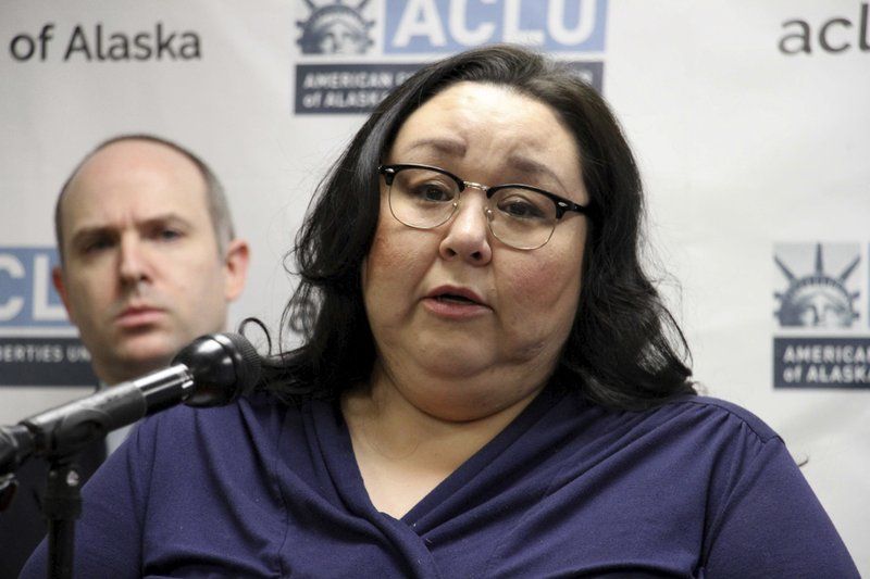Clarice Hardy speaks at a news conference Thursday, Feb. 20, 2020, in Anchorage, Alaska. The American Civil Liberties Union of Alaska filed a lawsuit Thursday on Hardy's behalf against the city of Nome, Alaska, and two former officers for failing to investigate the sexual assault report filed by Hardy, a former police dispatcher. On the left is Joshua Decker, executive director of the ACLU of Alaska. Image by AP Photo/Mark Thiessen. United States, 2020.