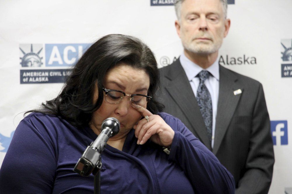 Clarice Hardy wipes a tear away from her eye during a news conference Thursday, Feb. 20, 2020, in Anchorage, Alaska. The American Civil Liberties Union of Alaska filed a lawsuit Thursday on Hardy's behalf against the City of Nome, Alaska, and two former officers for failing to investigate the sexual assault report filed by Hardy, a former police dispatcher. On the right is Stephen Koteff, the ACLU's legal director in Alaska. Image by AP Photo/Mark Thiessen. United States, 2020.