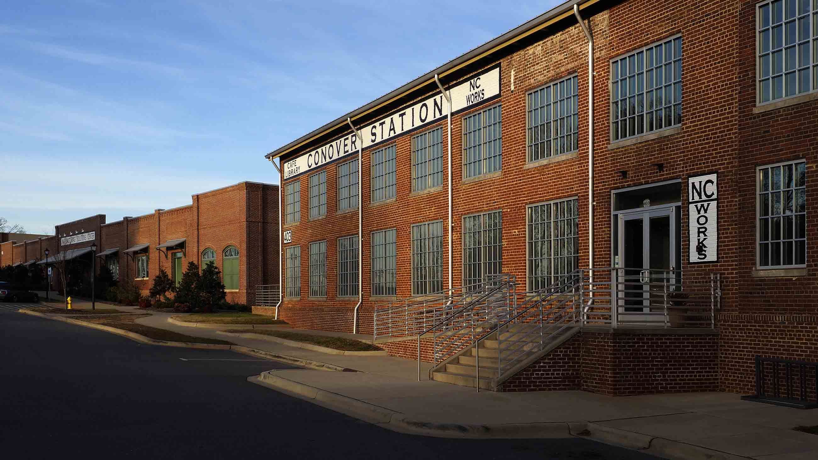 The Manufacturing Solutions Center is a sprawling innovation complex in Conover, providing research, training, and product testing for 1,500 companies worldwide. The building was designed to resemble the classic fabric mills of the early 20th century, such as the renovated Warlong Glove Manufacturing building seen here. Image by Larry C. Price. 