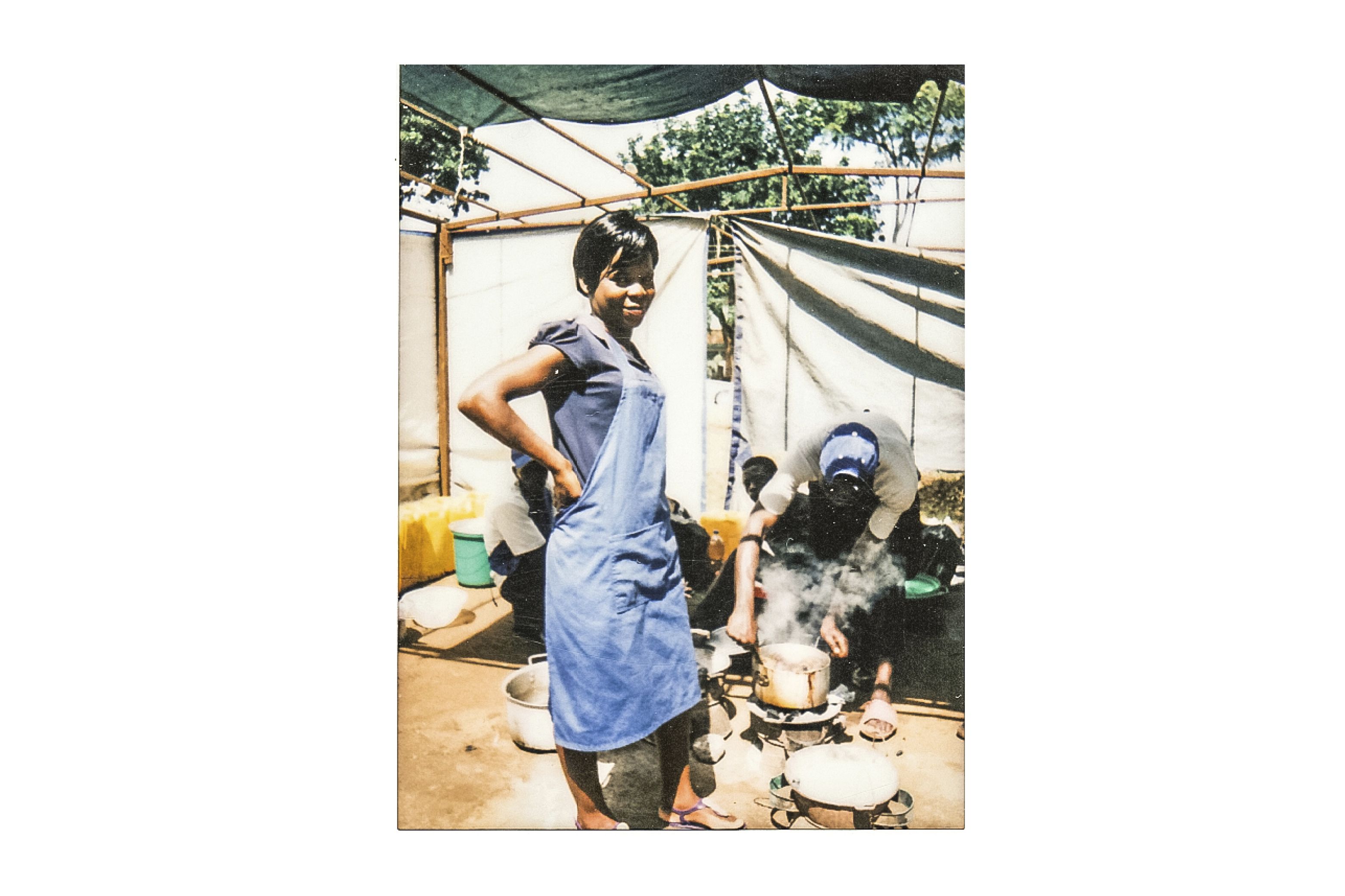 Annie Kanwara is a waitress at a roadside restaurant close to the Ministry of Information. She cooks on charcoal and says, "My customers don't like smoke." Image by Nathalie Bertrams. Malawi, 2017.