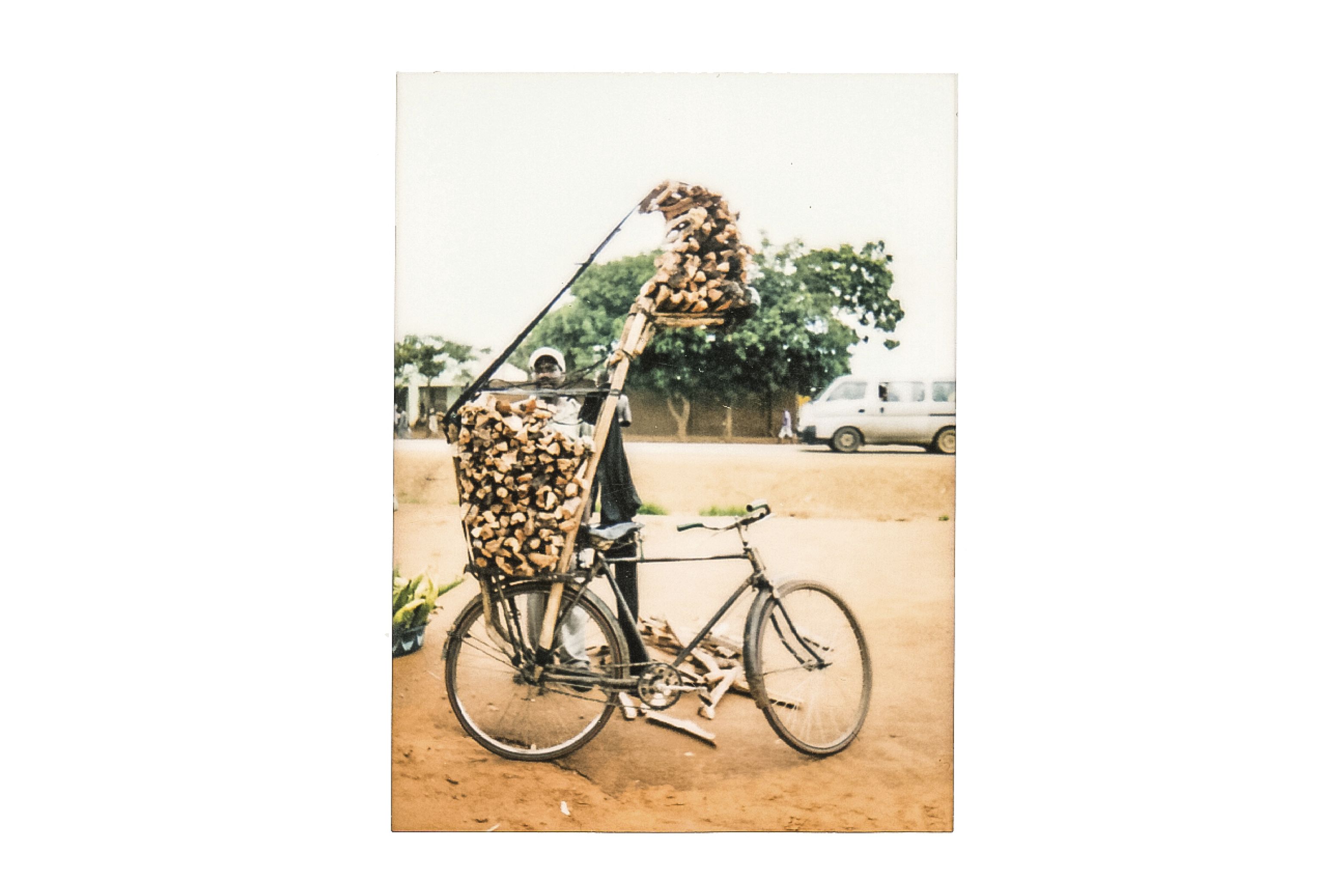 After this man sells firewood to his customers on the outskirts of Lilongwe, he cycles back 100 kilometers to his village.  Image by Nathalie Bertrams. Malawi, 2017.