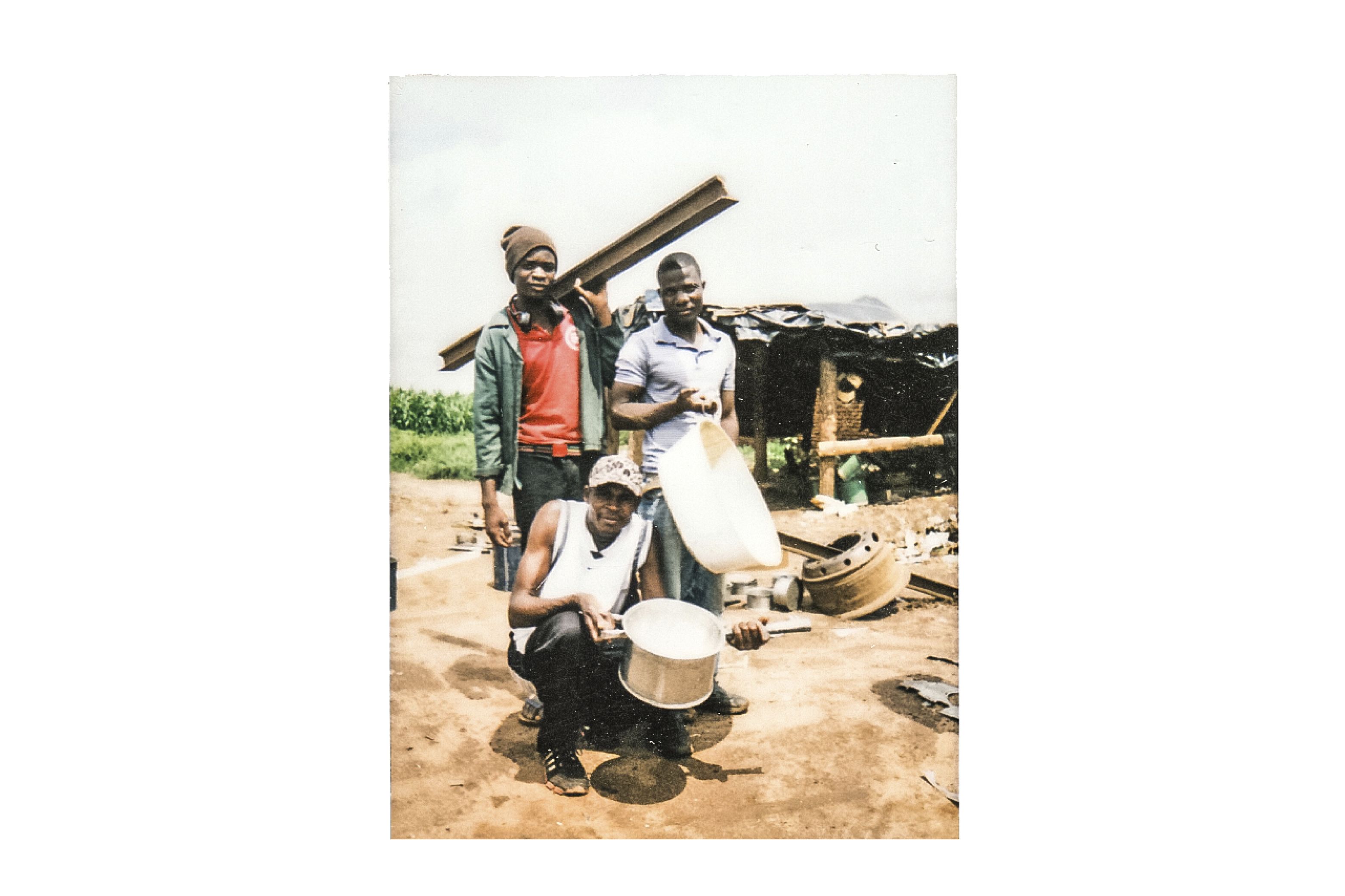The young men who are producing simple charcoal stoves say they can only work when "we have a zinc sheet from a roof." Image by Nathalie Bertrams. Malawi, 2017.
