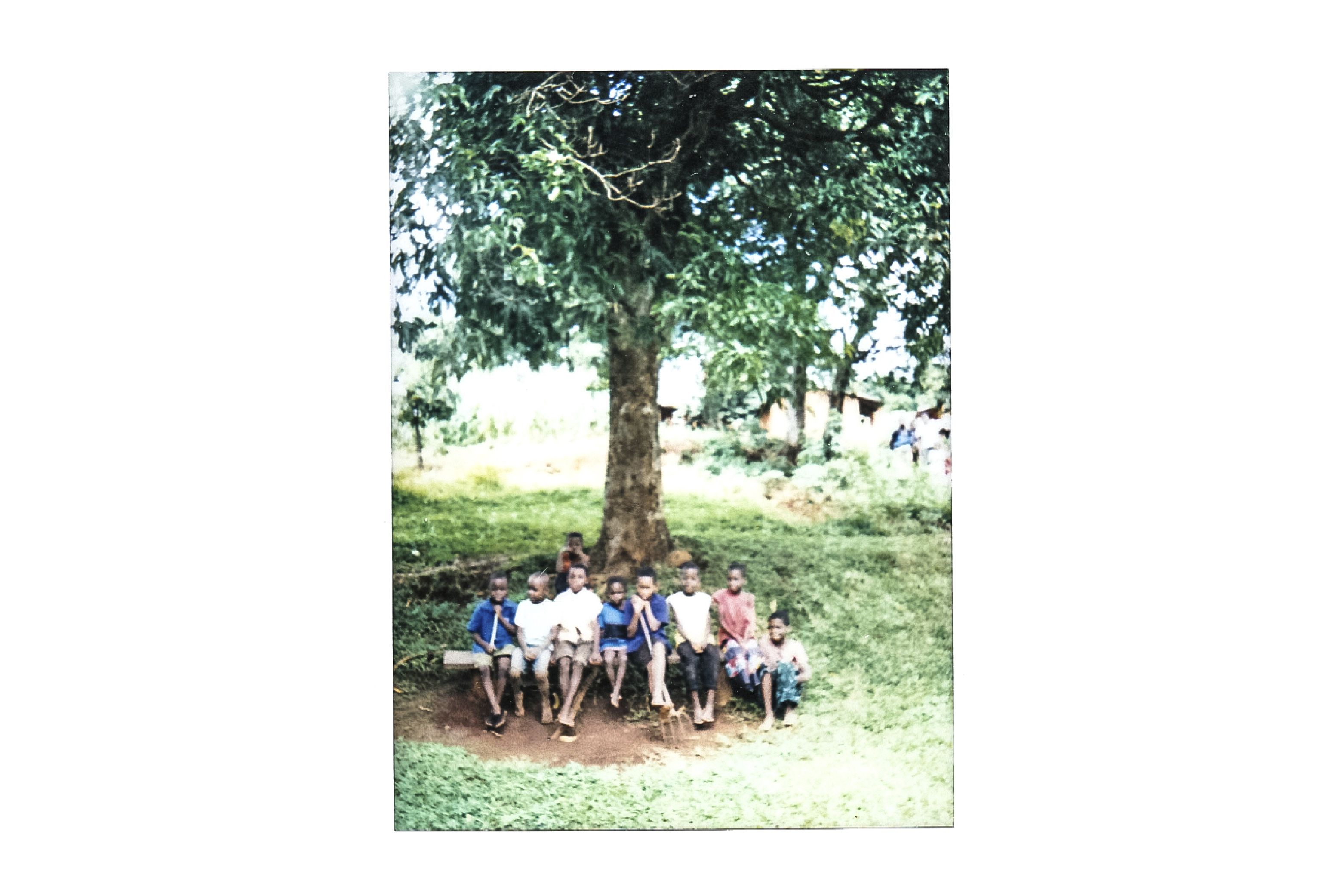 Kids under a tree in Mulema village The village chief has issued a strict law against the felling of trees, and people are encouraged to replant. Image by Nathalie Bertrams. Malawi, 2017. 
