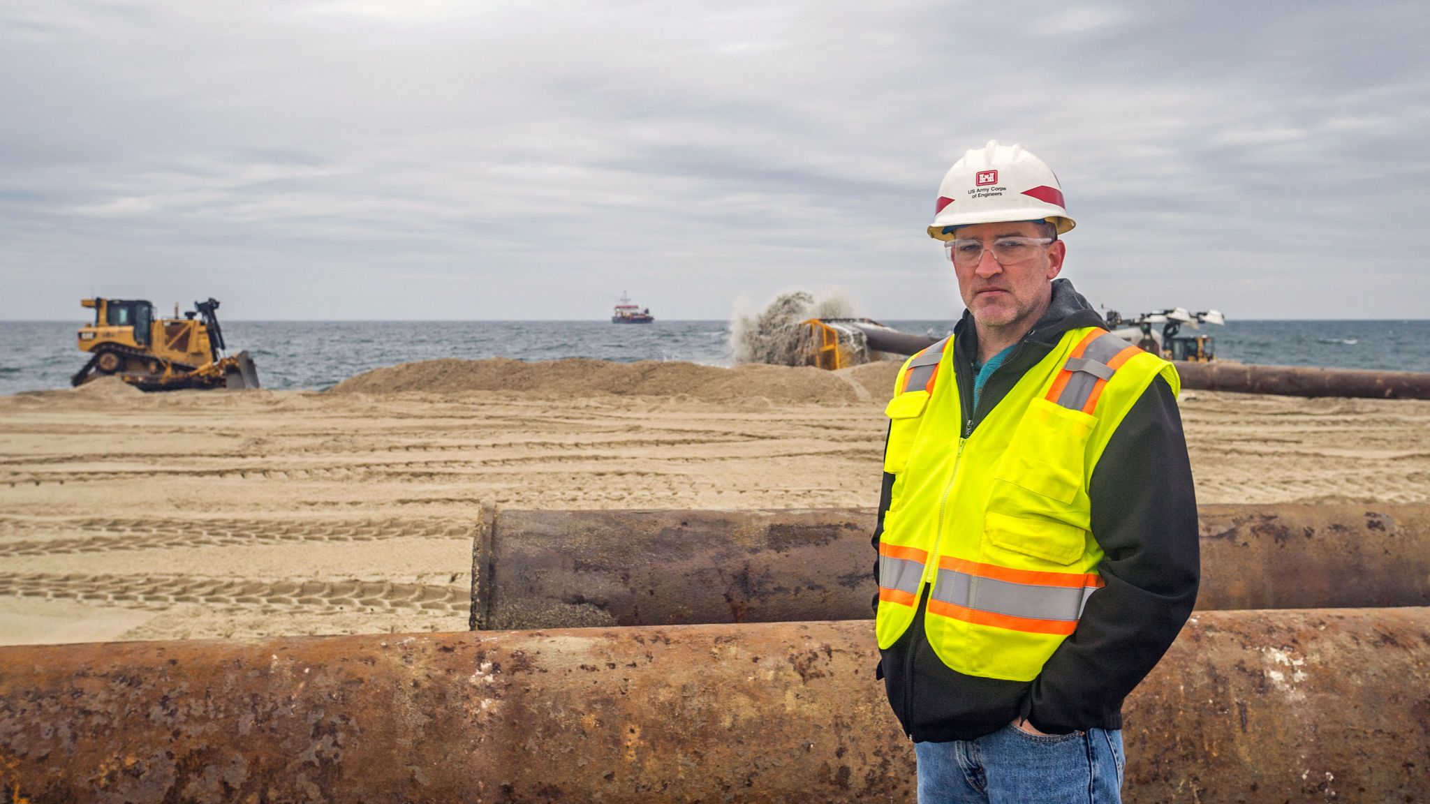 Jason Shea is the project manager for the beach renourishment initiative at Sea Bright. The dredge ship Magdalen is on the horizon. Image courtesy of NJ Spotlight. United States, undated.