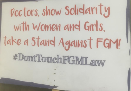 Another sign placed at Equality Now tells doctors to fight FGM and not interfere with the law. Image by Merdie Nzanga. Kenya, 2018.
