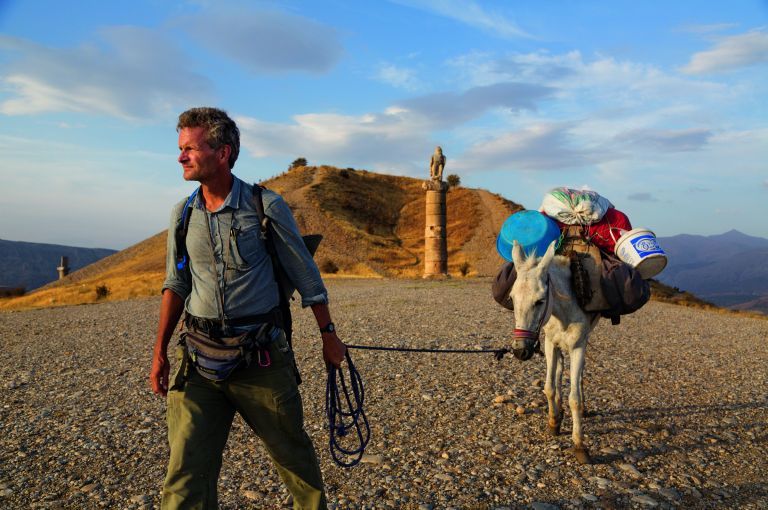 In eastern Turkey, Paul Salopek leads his mule past the Karakuş royal tomb, built in the first century B.C. by one of the area’s many ruling states. When Syrians began to pour over the border 70 miles to the south, he and photographer John Stanmeyer drove down separately to report on the situation. Image by by John Stanmeyer/National Geographic.