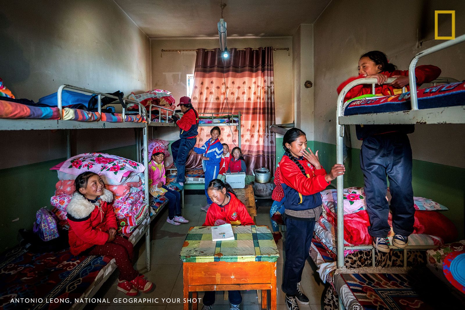 “Far away from the nearest modernized city in Qinghai, I traveled with Oxfam for about 10 hours to visit the Tibetan students staying in this boarding school. Instead of rushing back to their room after lunch to play with their smartphone or tablet, these kids are finding a suitable place in this small room packed with eight students so they can take out their books and start studying.” Image by Antonio Leon, National Geographic Your Shot. China, 2017.