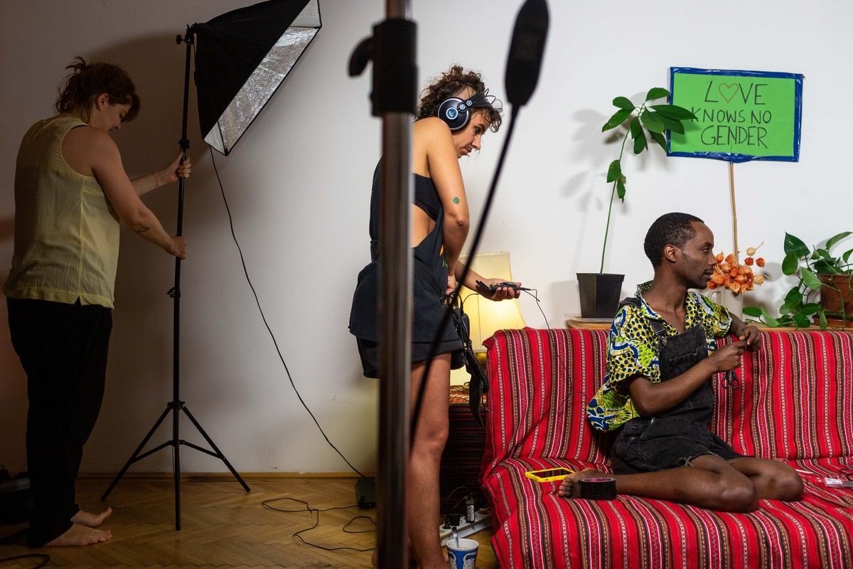 Faris (right), 35, from Addis Ababa, Ethiopia identifies as non-binary, and now lives in Vienna, Aurstia, where he was granted political asylum in July 2017. As part of a series of online videos about LGBTI+ rights in Amharic, Faris chats with his co-host Noël during a break in filming in his living room. Image by Bradley Secker. Austria, 2020.points, and was arrested and tortured by both. Image by Bradley Secker. Germany, 2020.