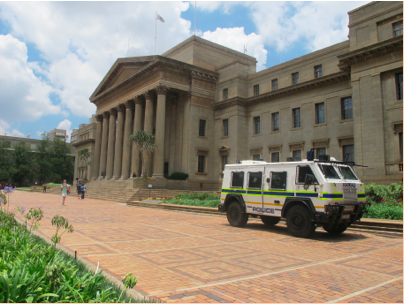A RG-12, nicknamed Nyala, is an armored police vehicle at the University of Witwatersrand and is the same police vehicle that Siwo and her peers faced during the Braamfontein protests. The registration period had just started and the Nyala along with five police cars not-pictured rest on stand-by. Image by Lorraine Pettit. South Africa, 2016.
